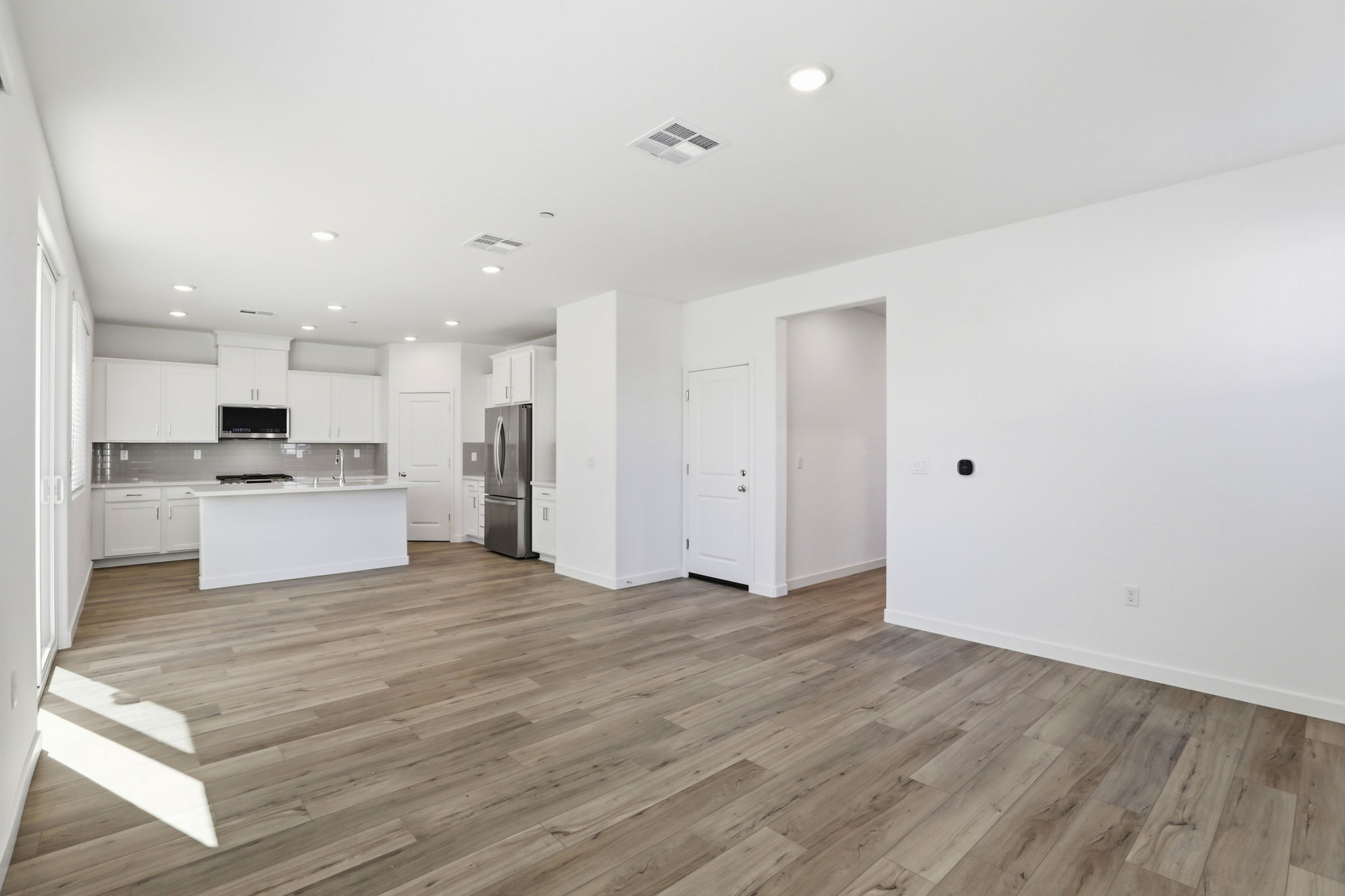A large kitchen with white cabinets.