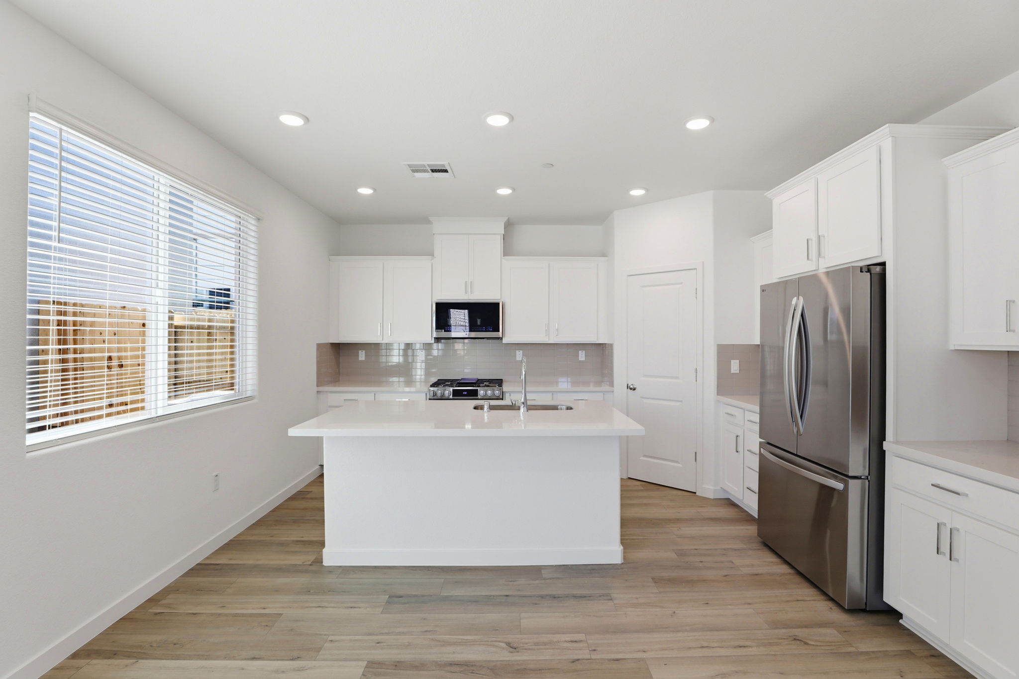 A kitchen with white cabinets.