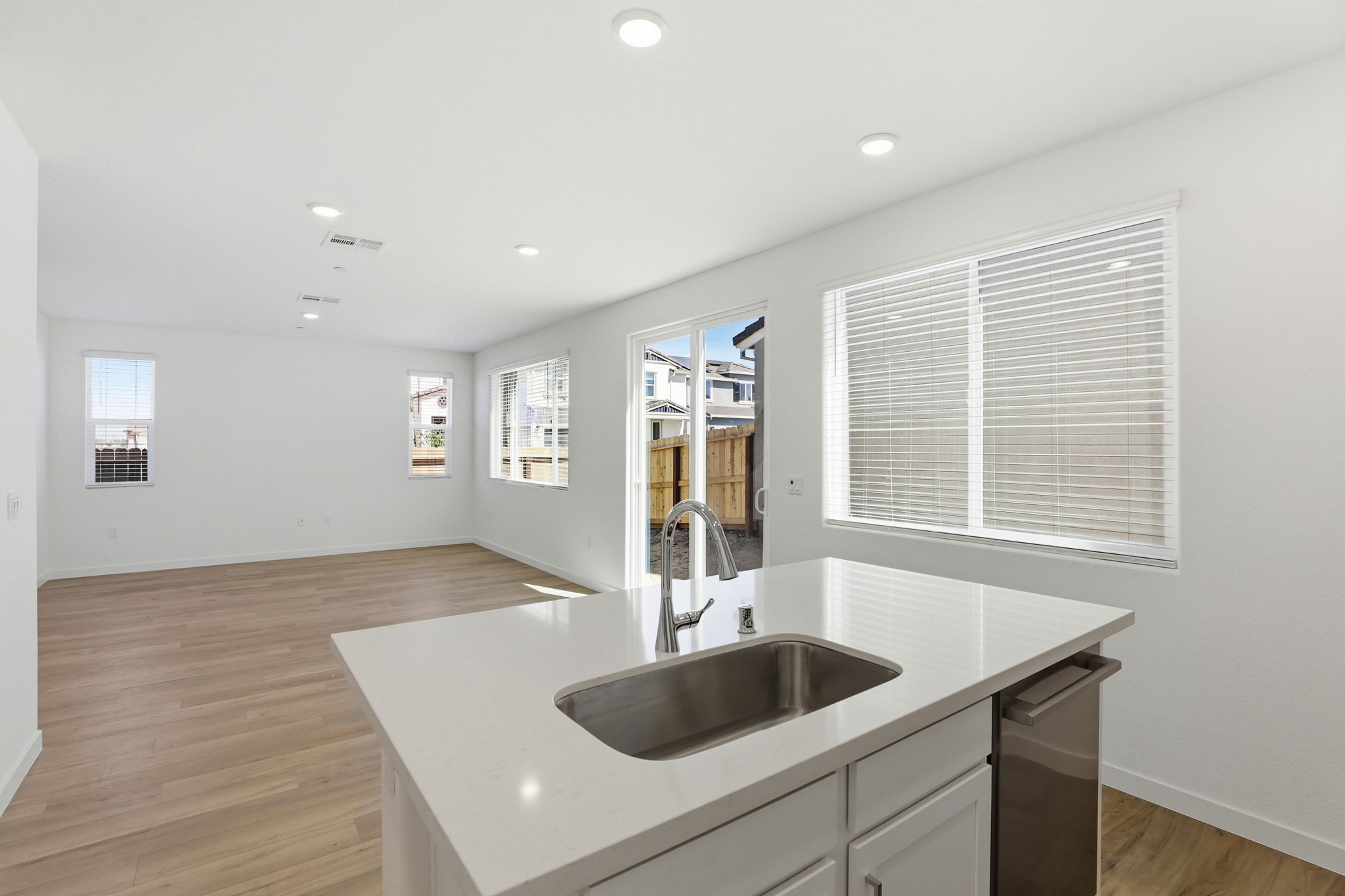 A kitchen with a sink and a mirror.