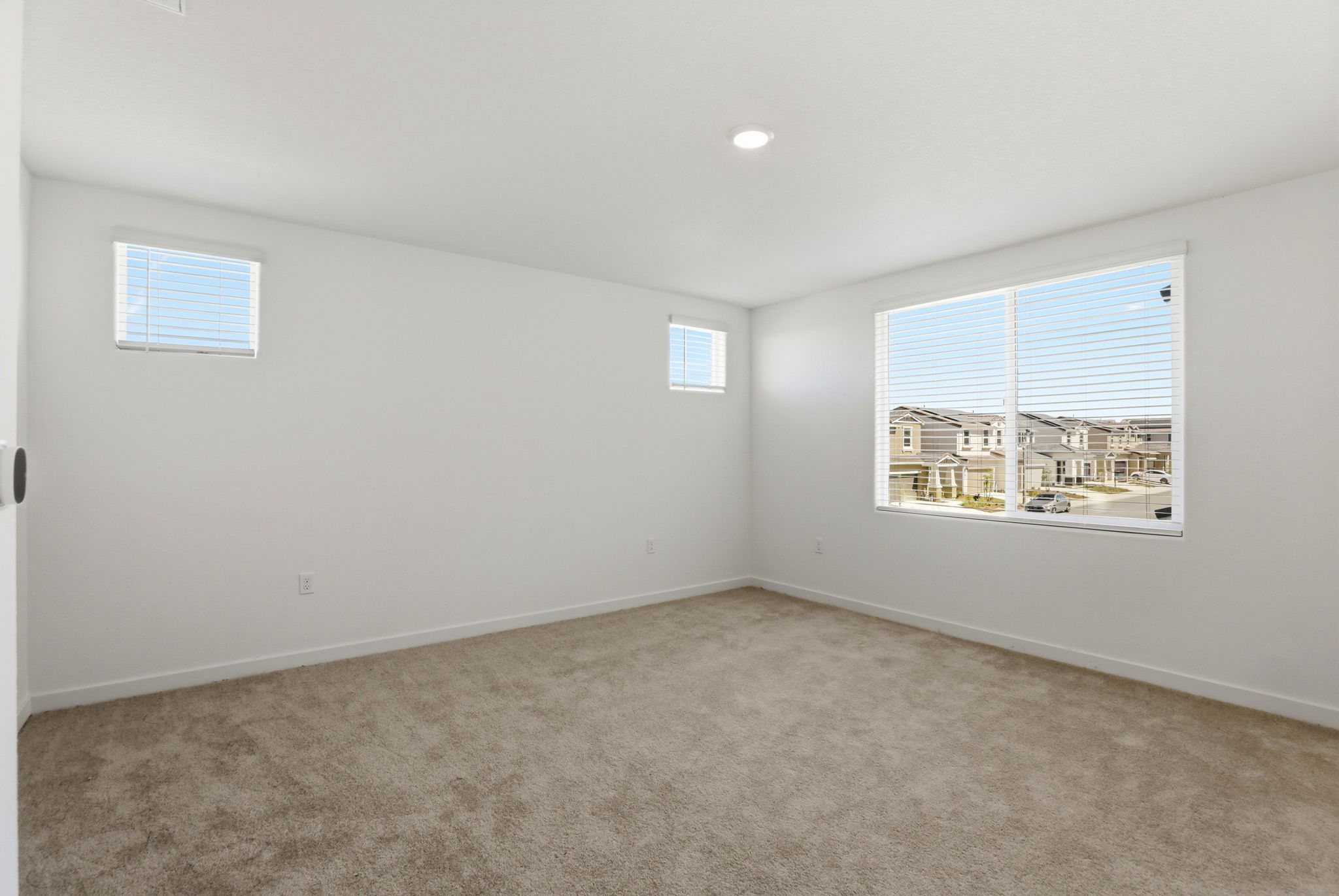 A room with a window and a carpet.