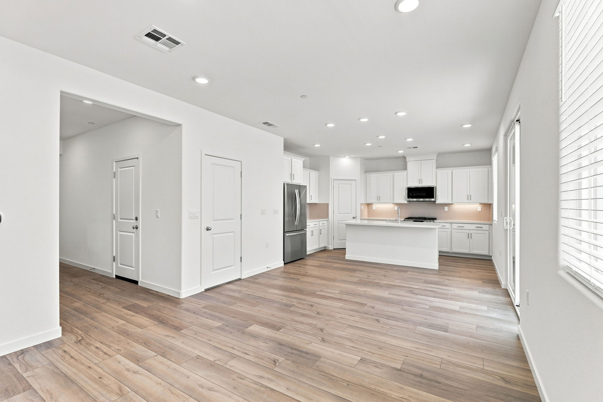 A large kitchen with white cabinets.