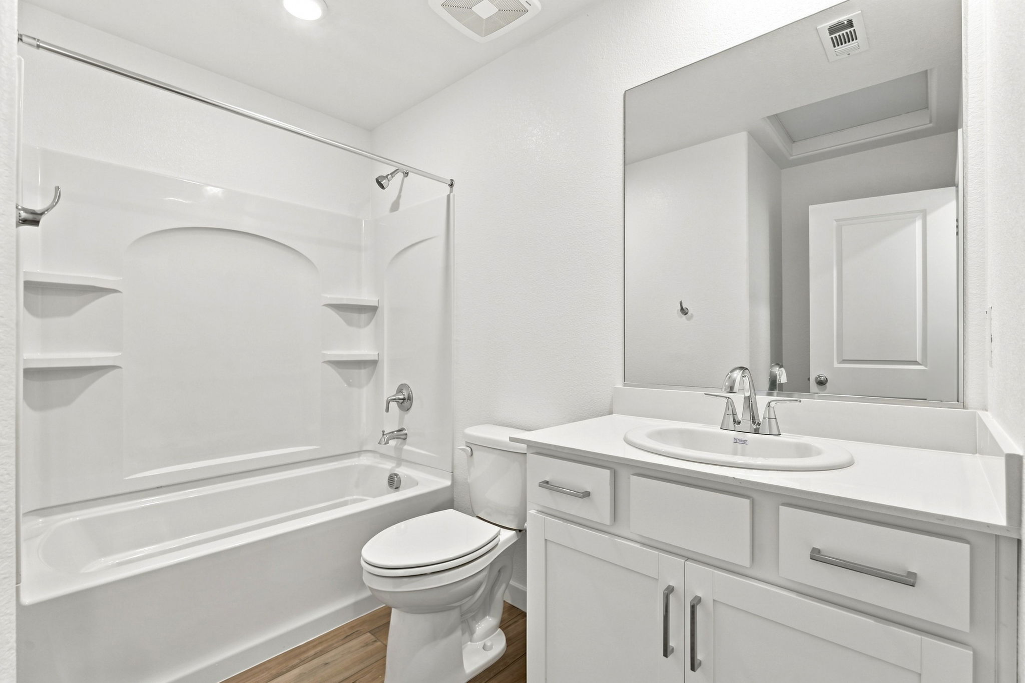 A bathroom with a tub sink and toilet.