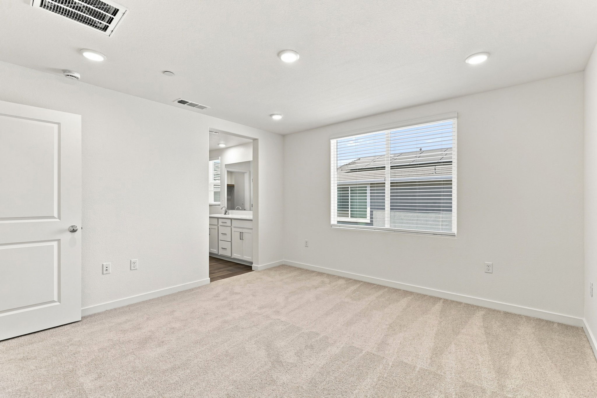 A room with white walls and a window.