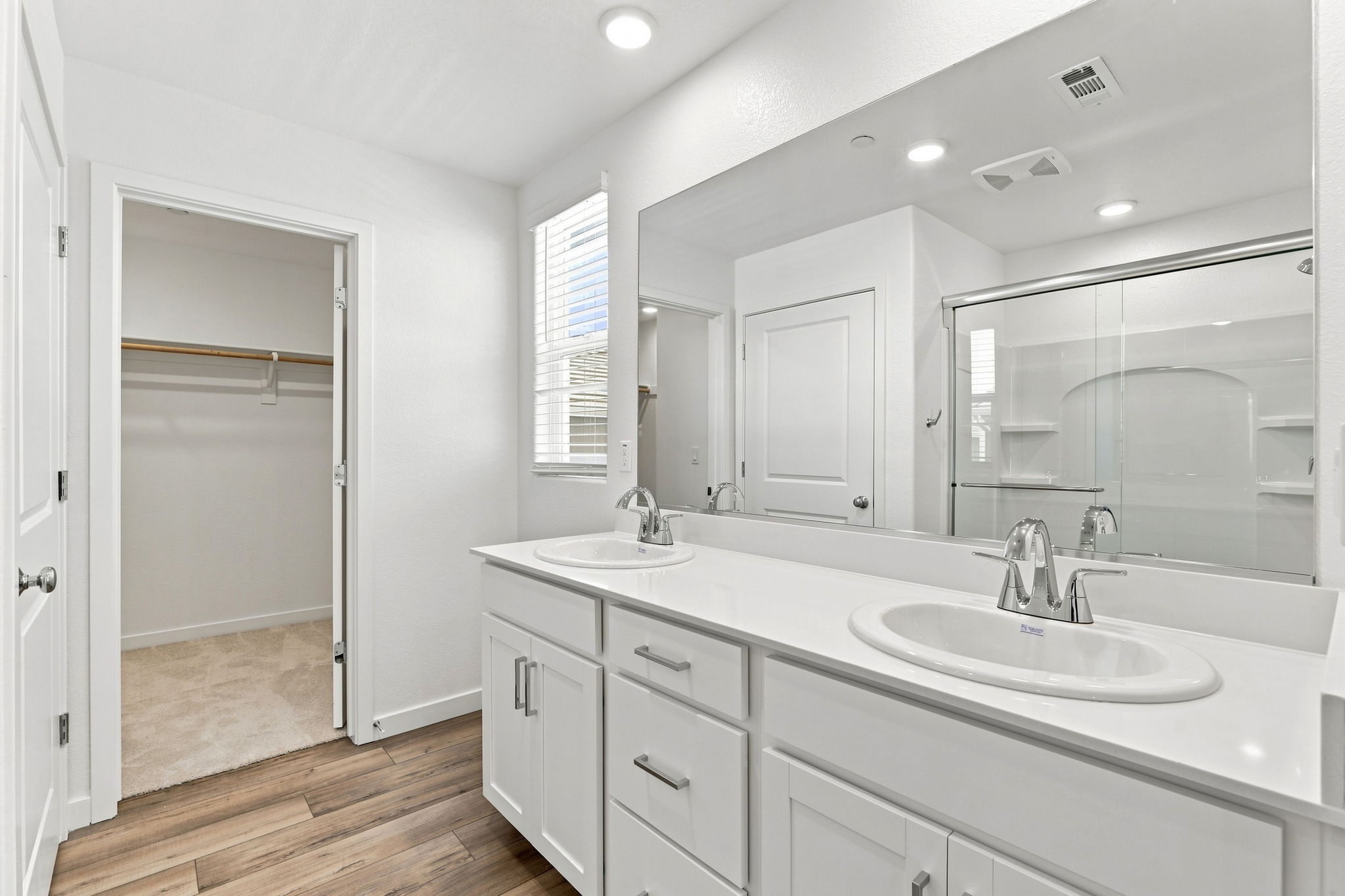 A bathroom with a large mirror.