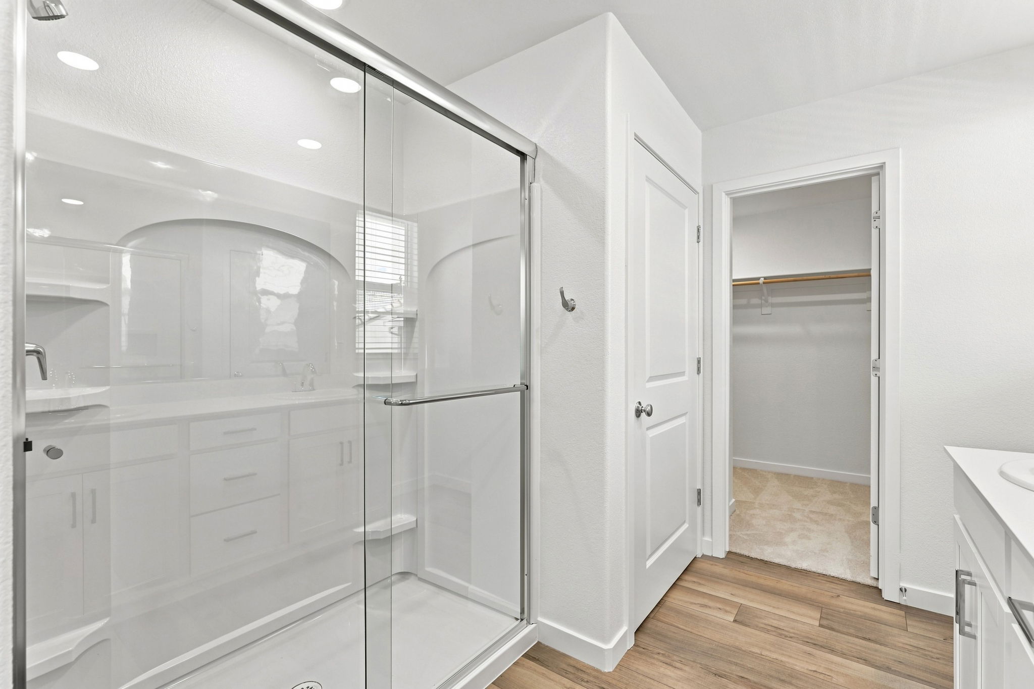 A bathroom with white cabinets.