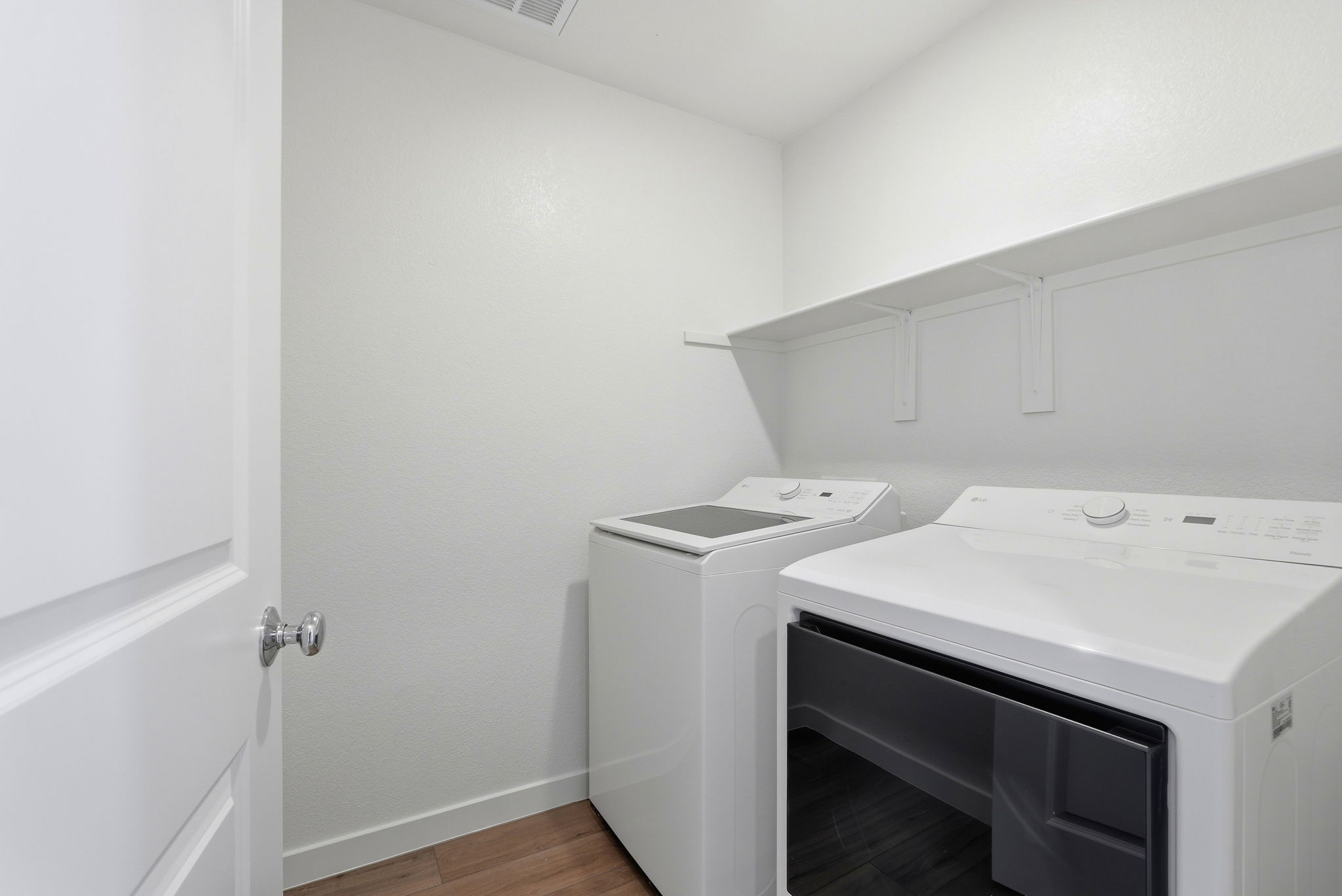 A white room with a washer and dryer.