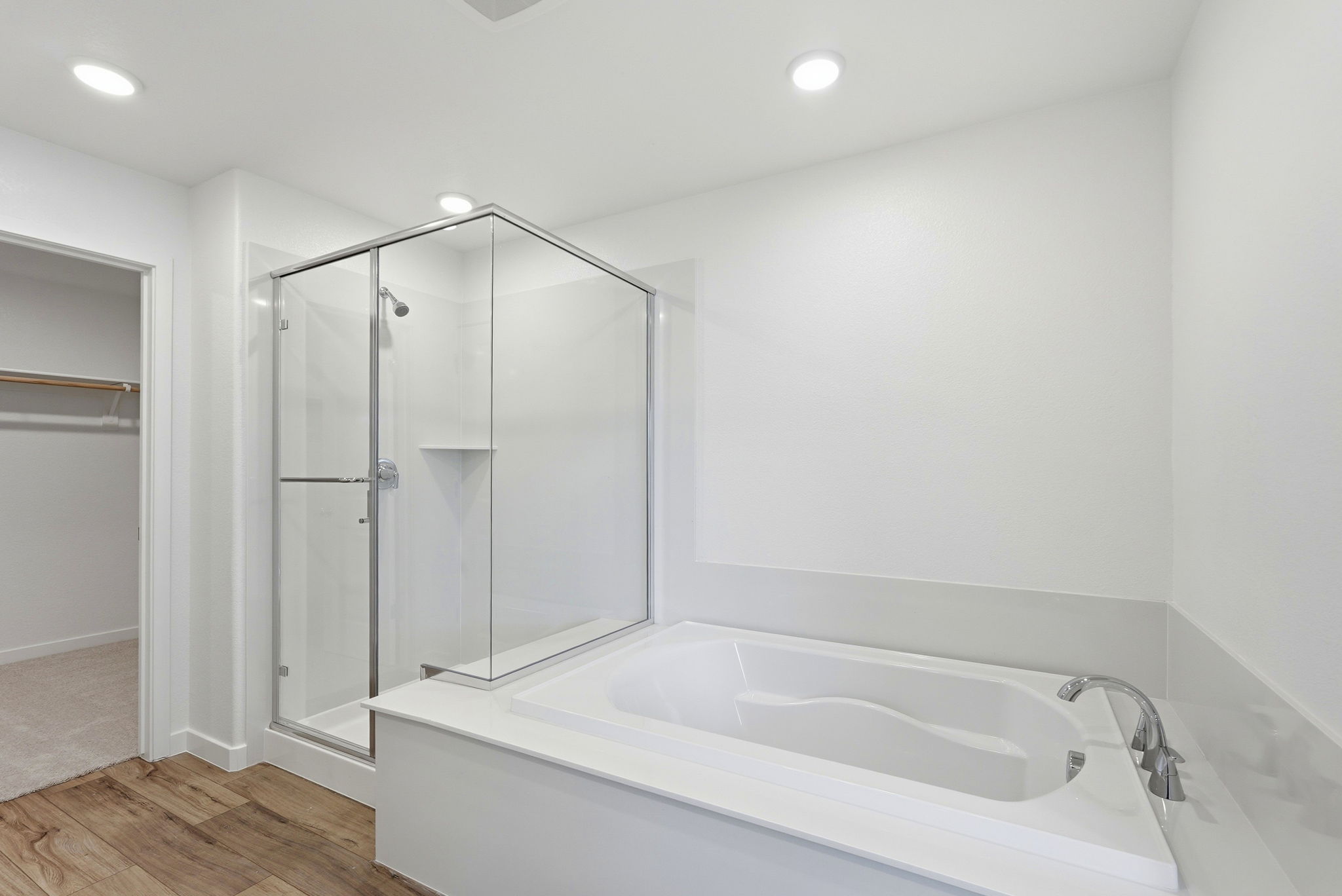 A white bathroom with a glass shower.