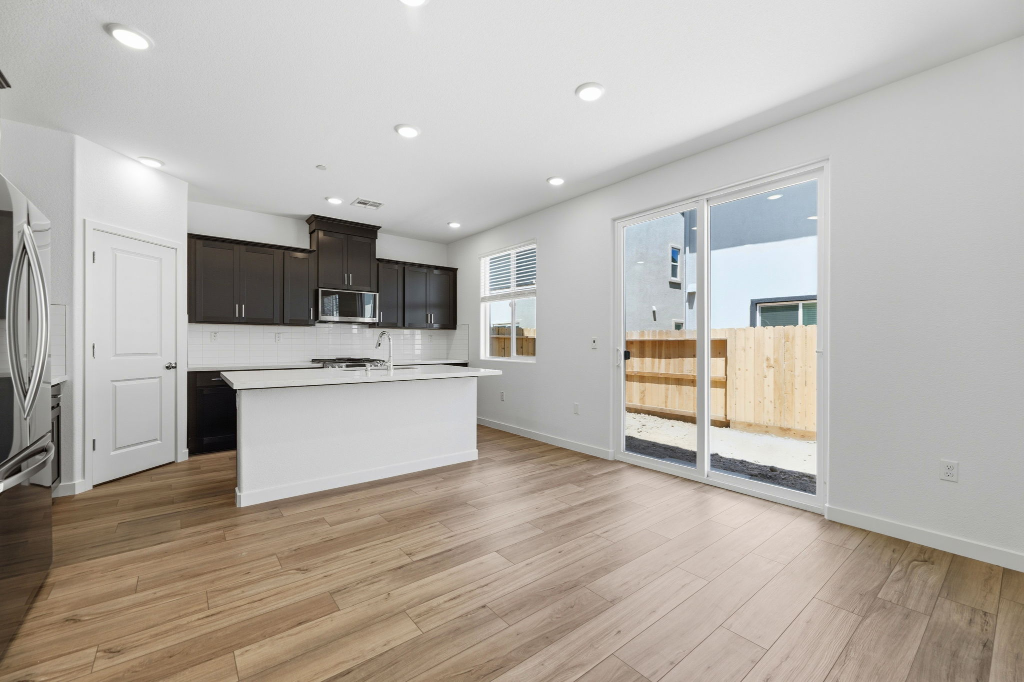 A kitchen with white cabinets.