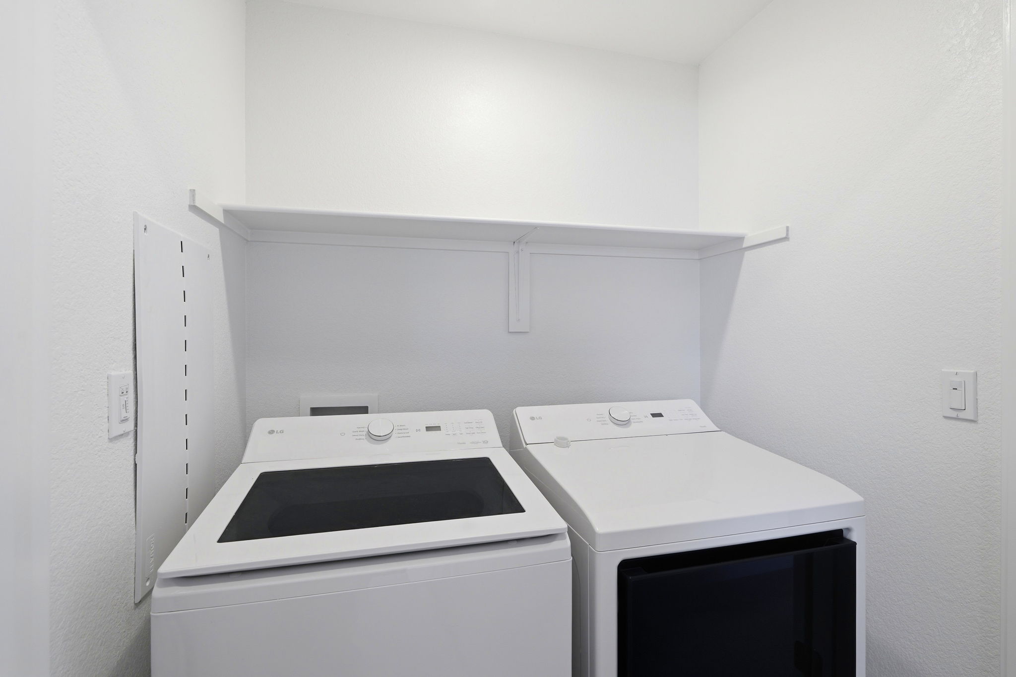A white shelf with a black and white printer on it.