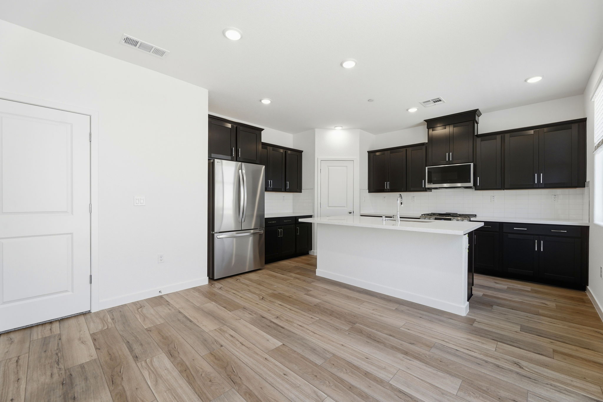 A kitchen with black cabinets.