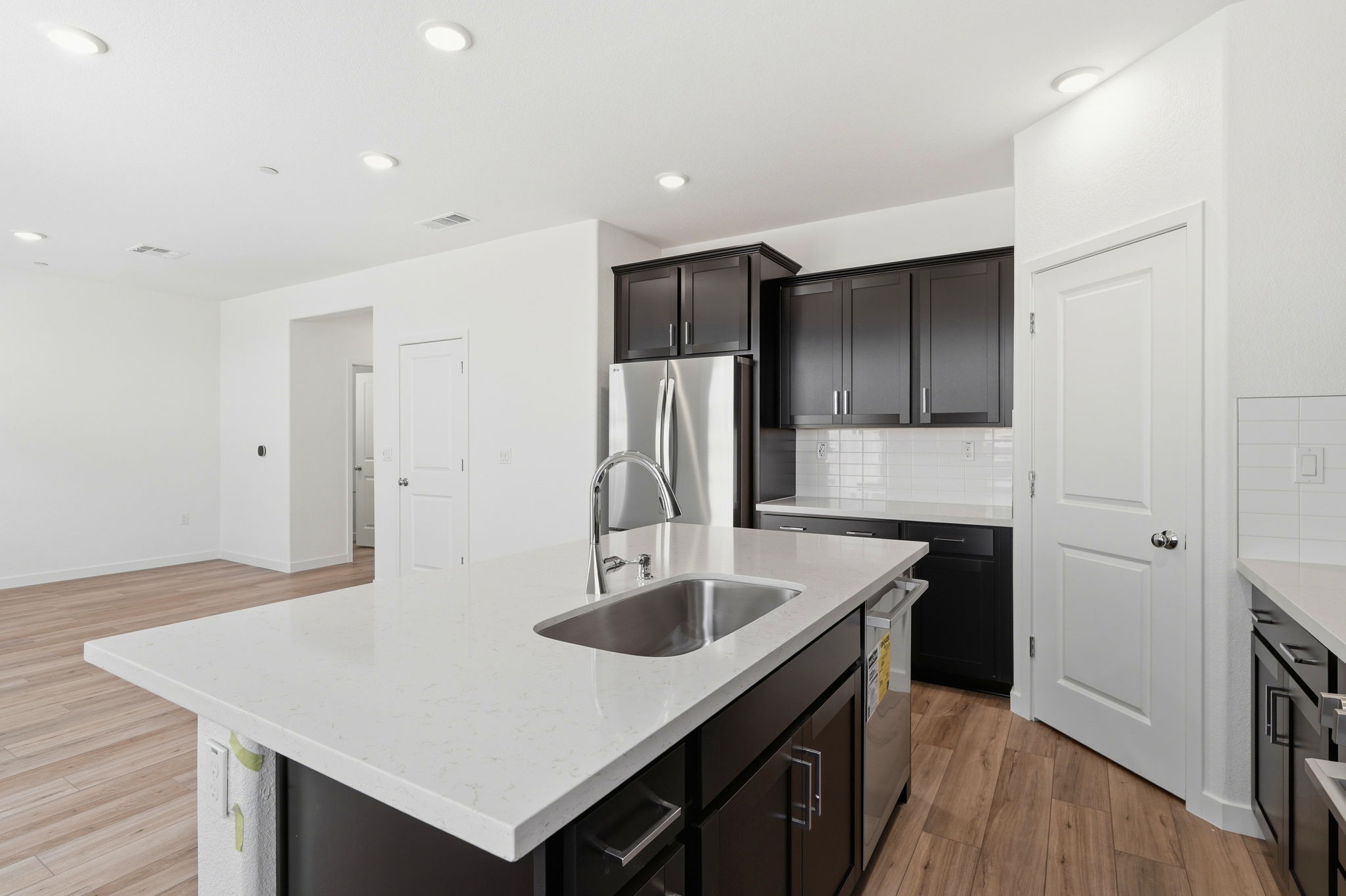 A kitchen with black cabinets.