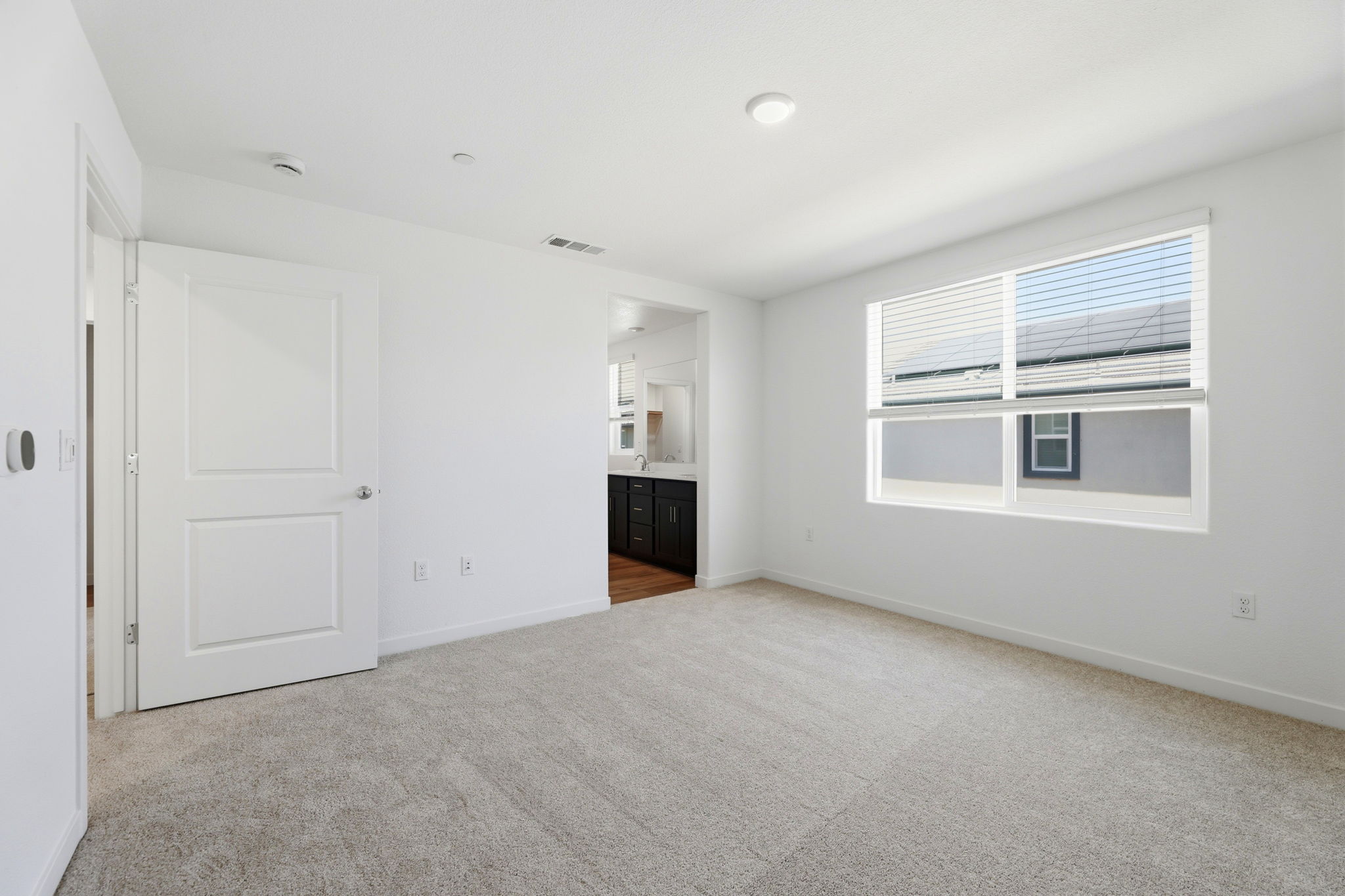 A room with white walls and a window.