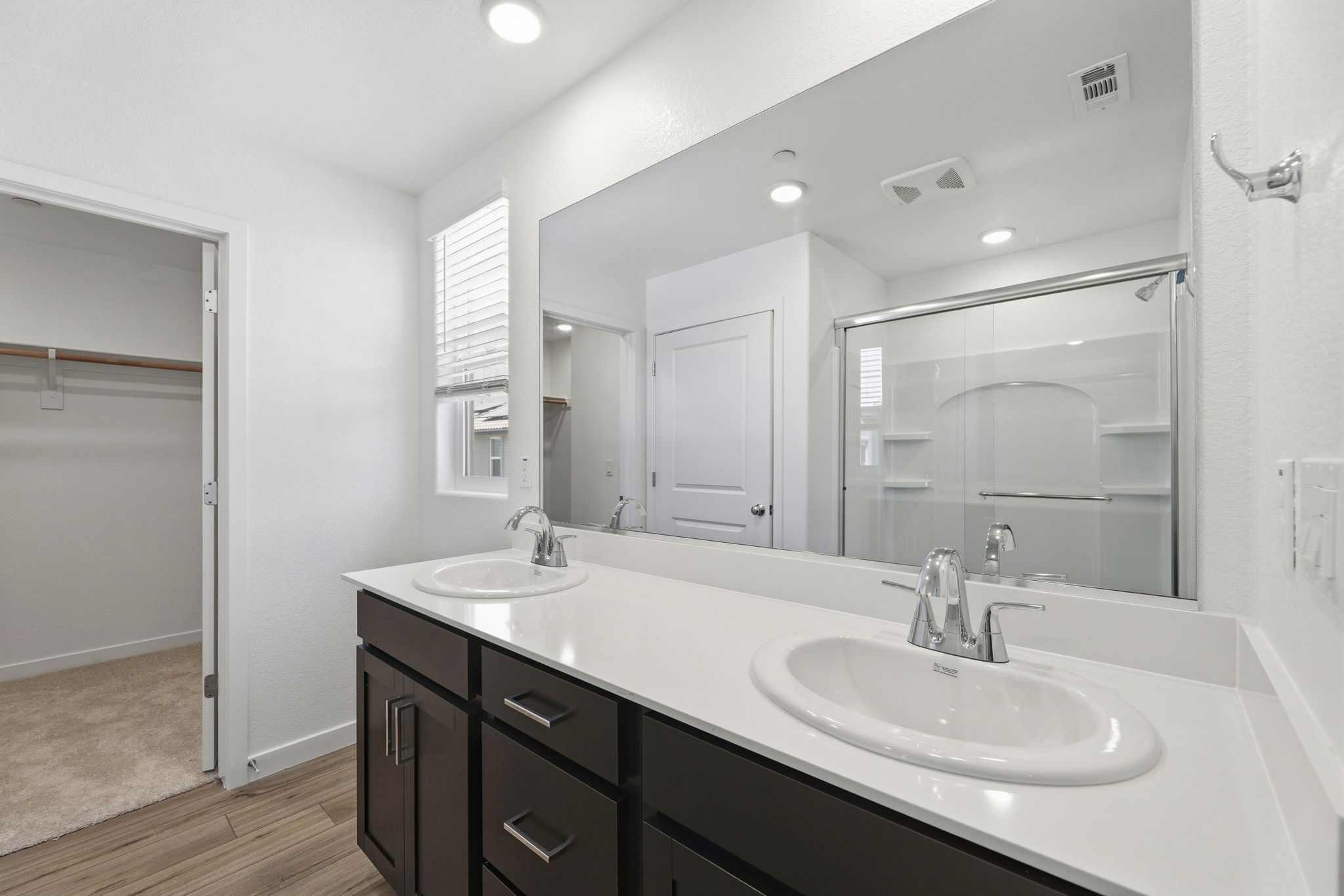 A bathroom with a large mirror.
