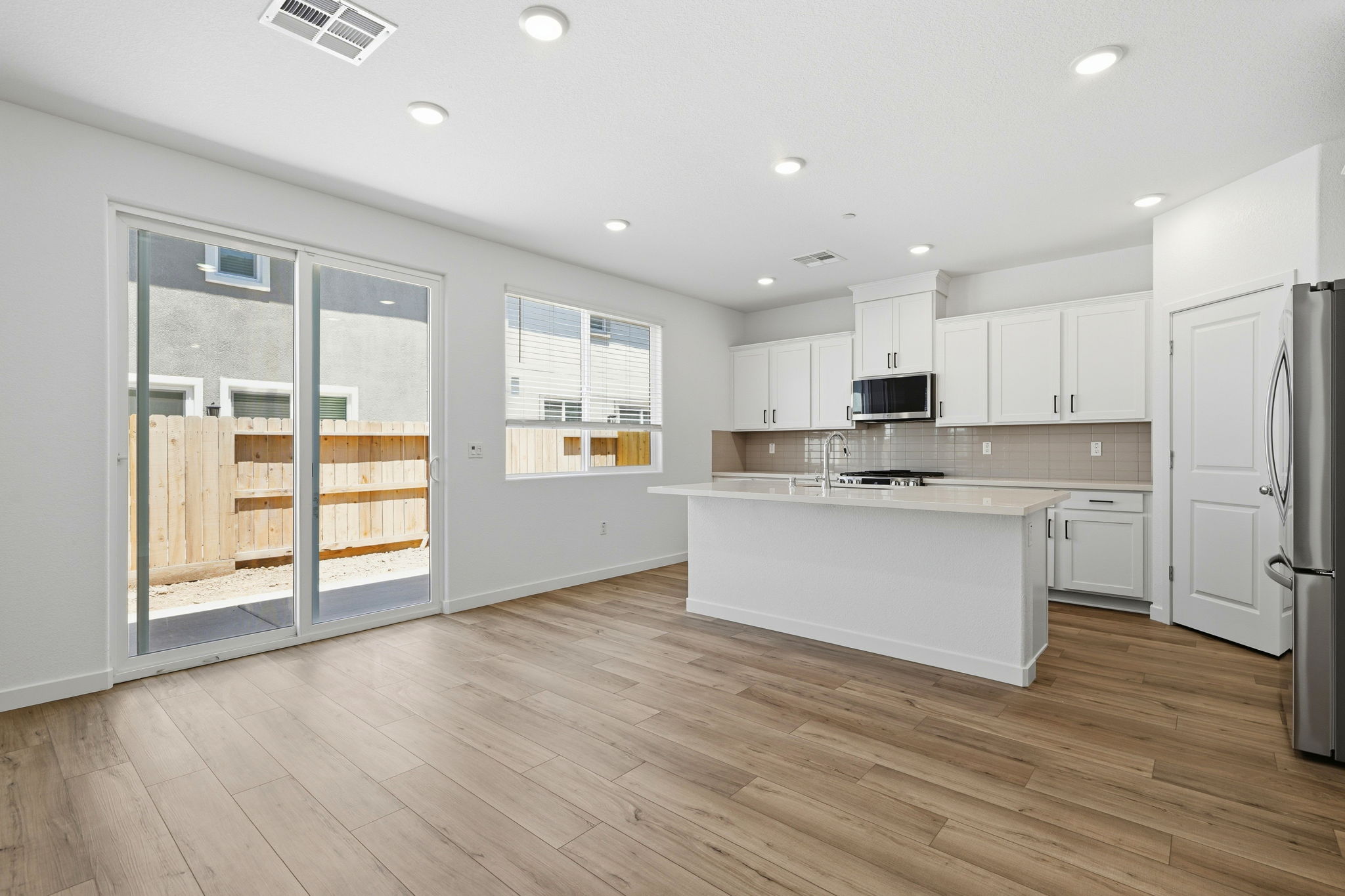 A kitchen with white cabinets.