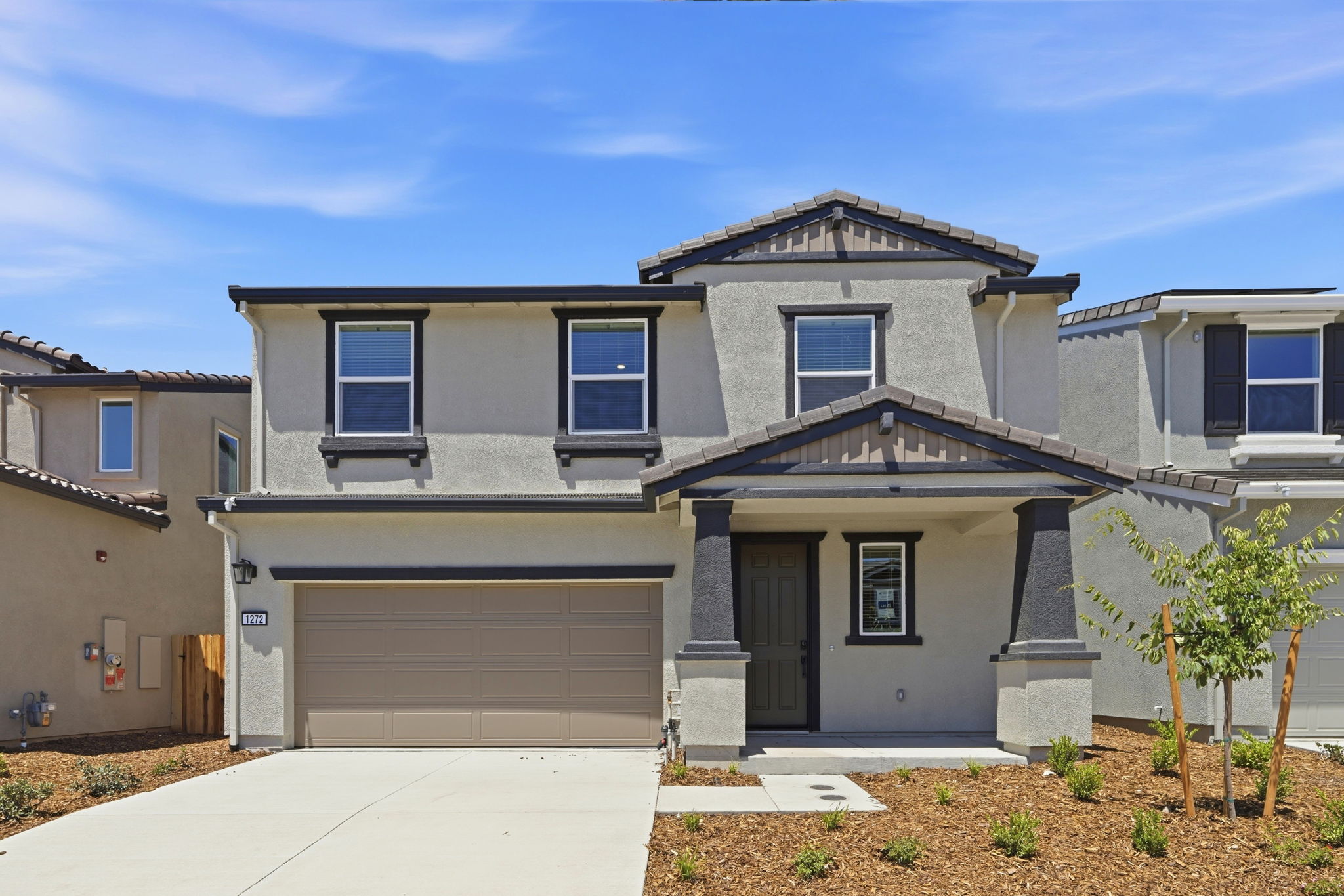 A house with garages and a driveway.