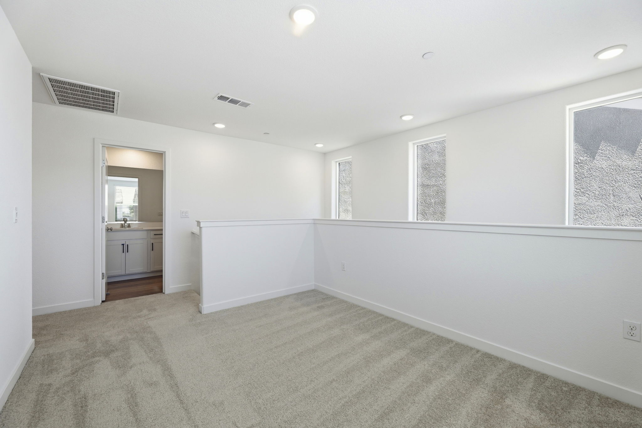 A room with a white wall and a sink.