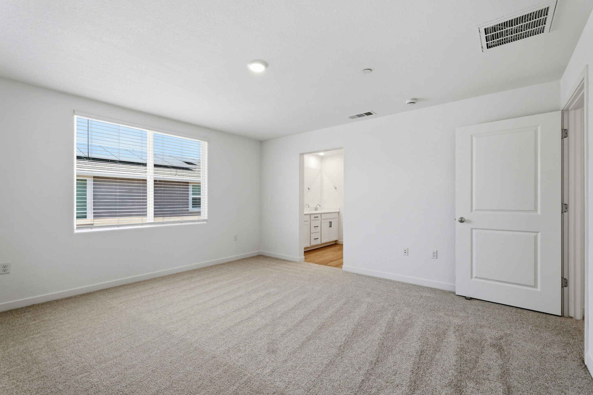 A room with white walls and a window.
