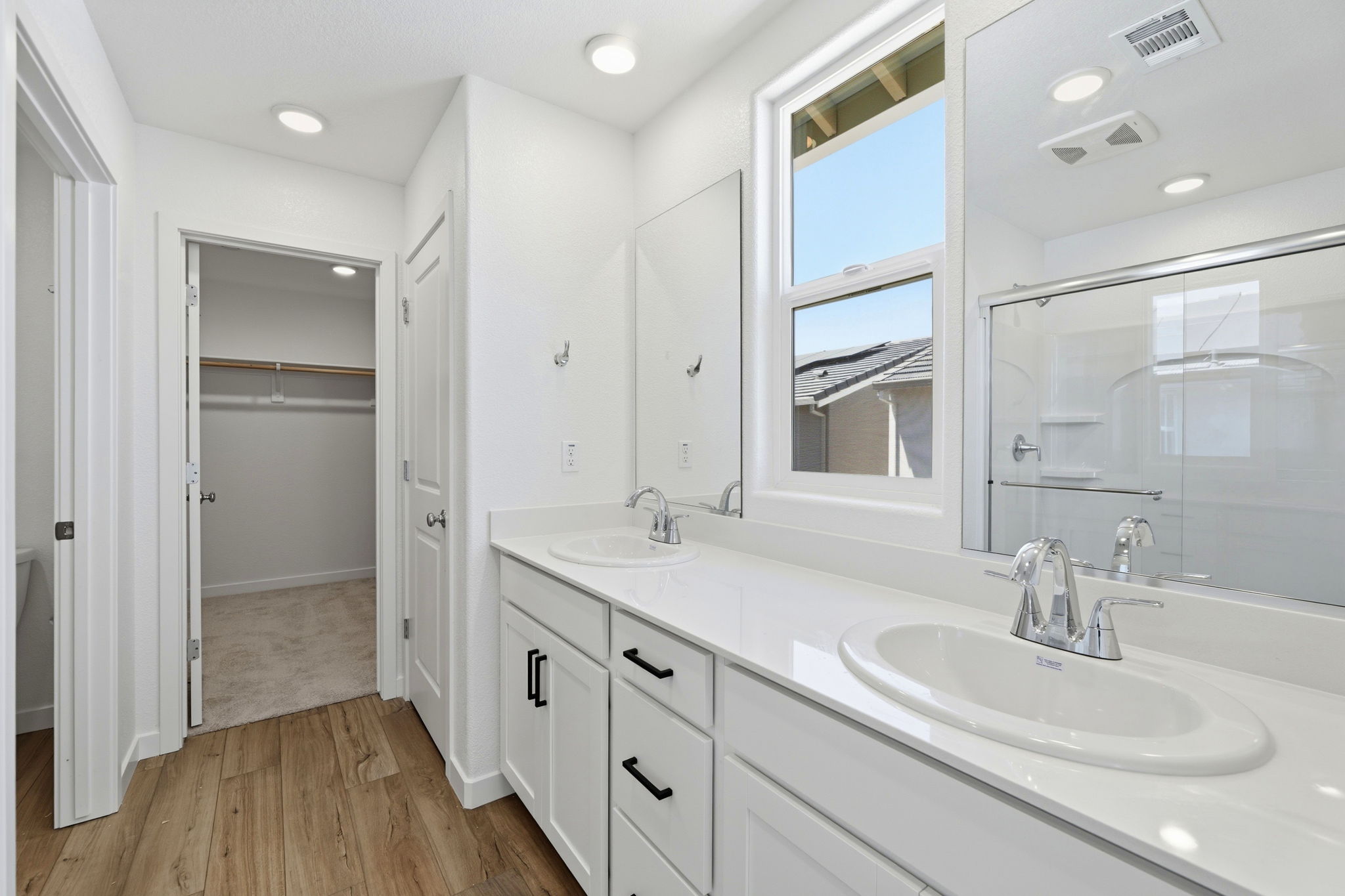 A bathroom with a large mirror.