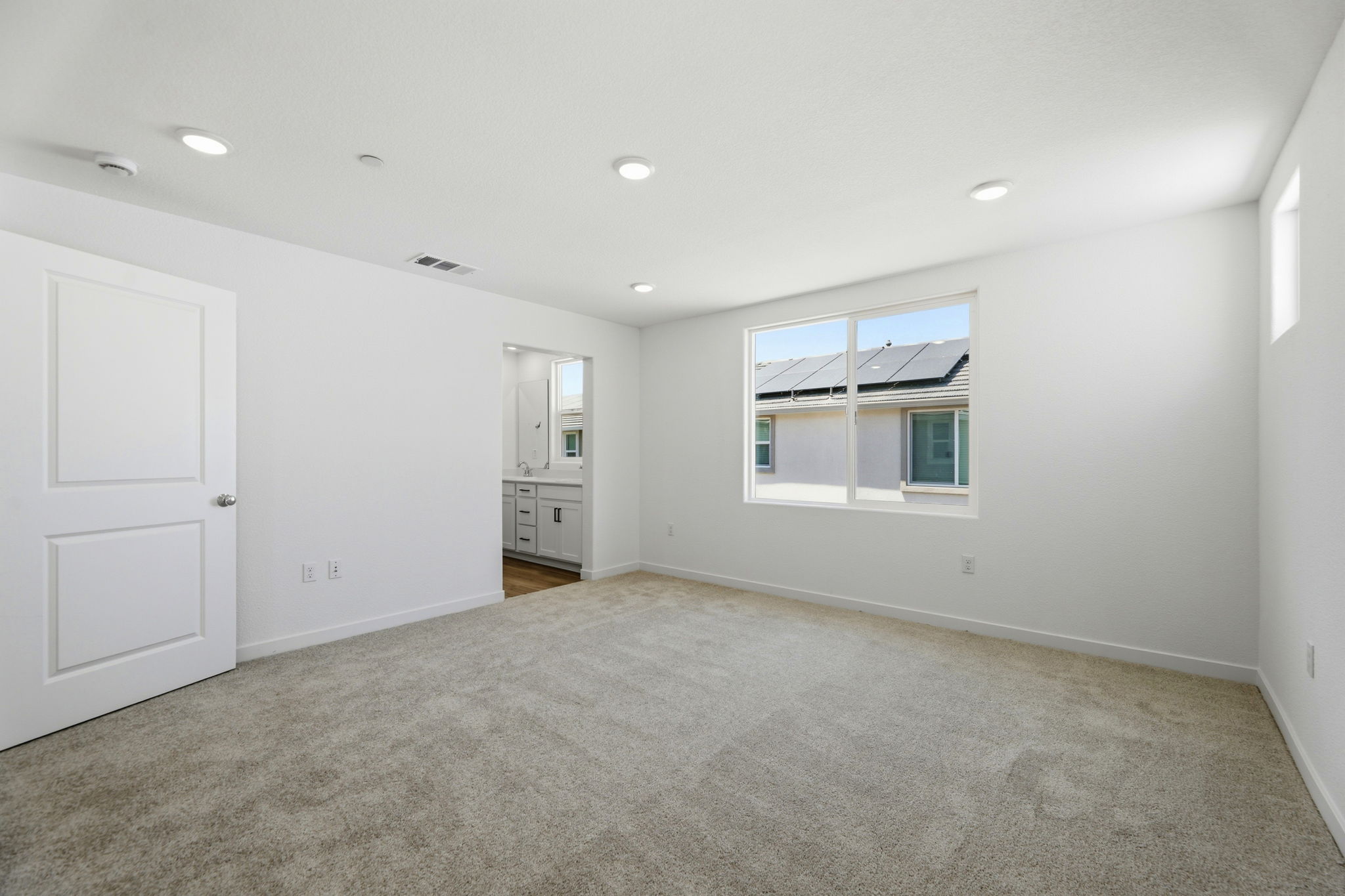 A room with white walls and a window.
