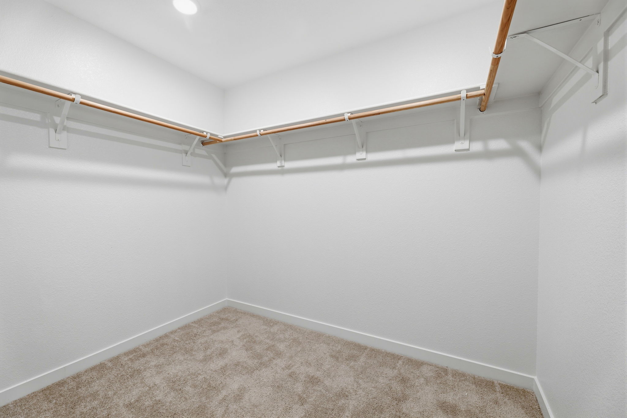 A white room with a carpet.