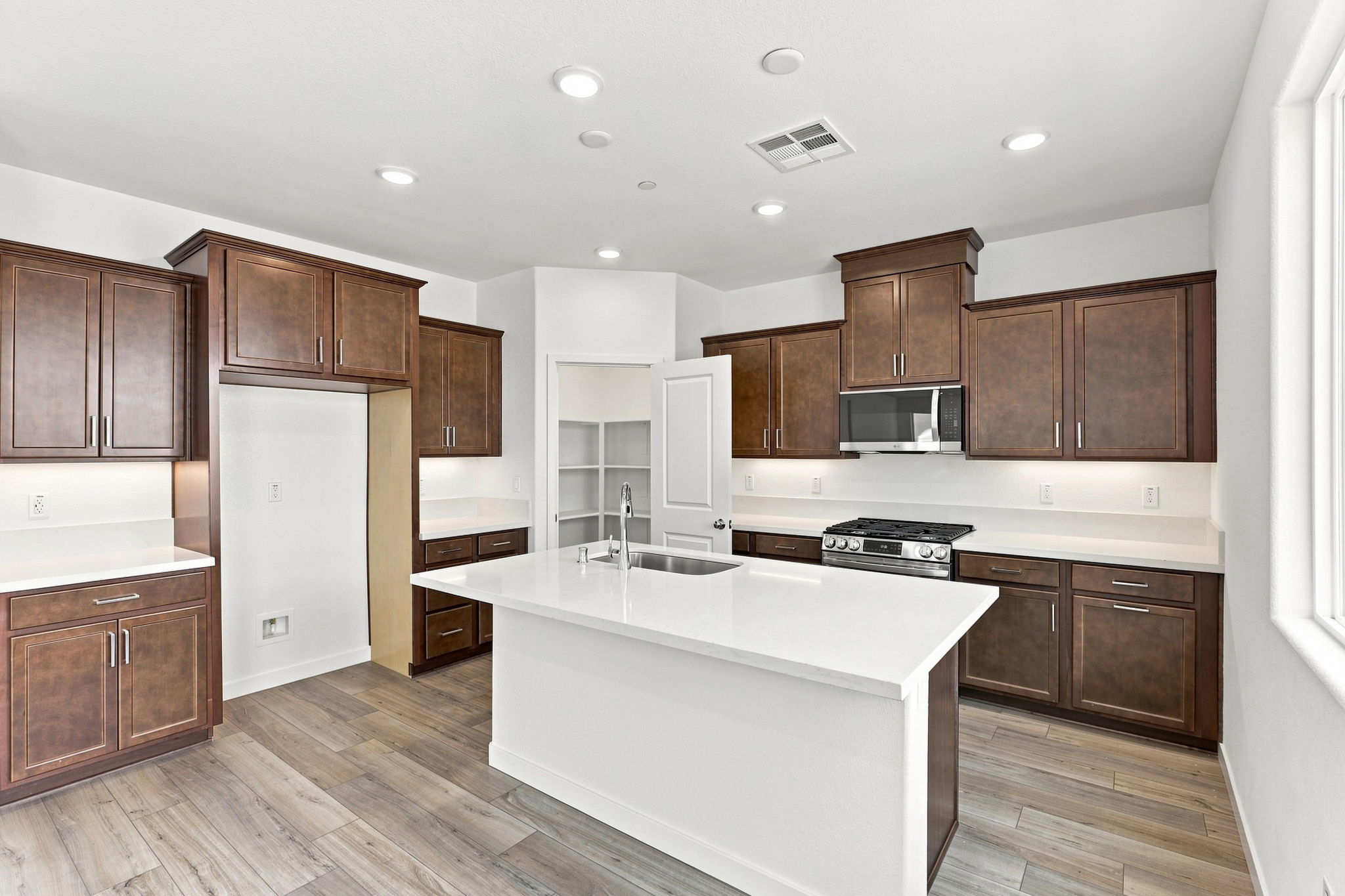 A kitchen with wooden cabinets.