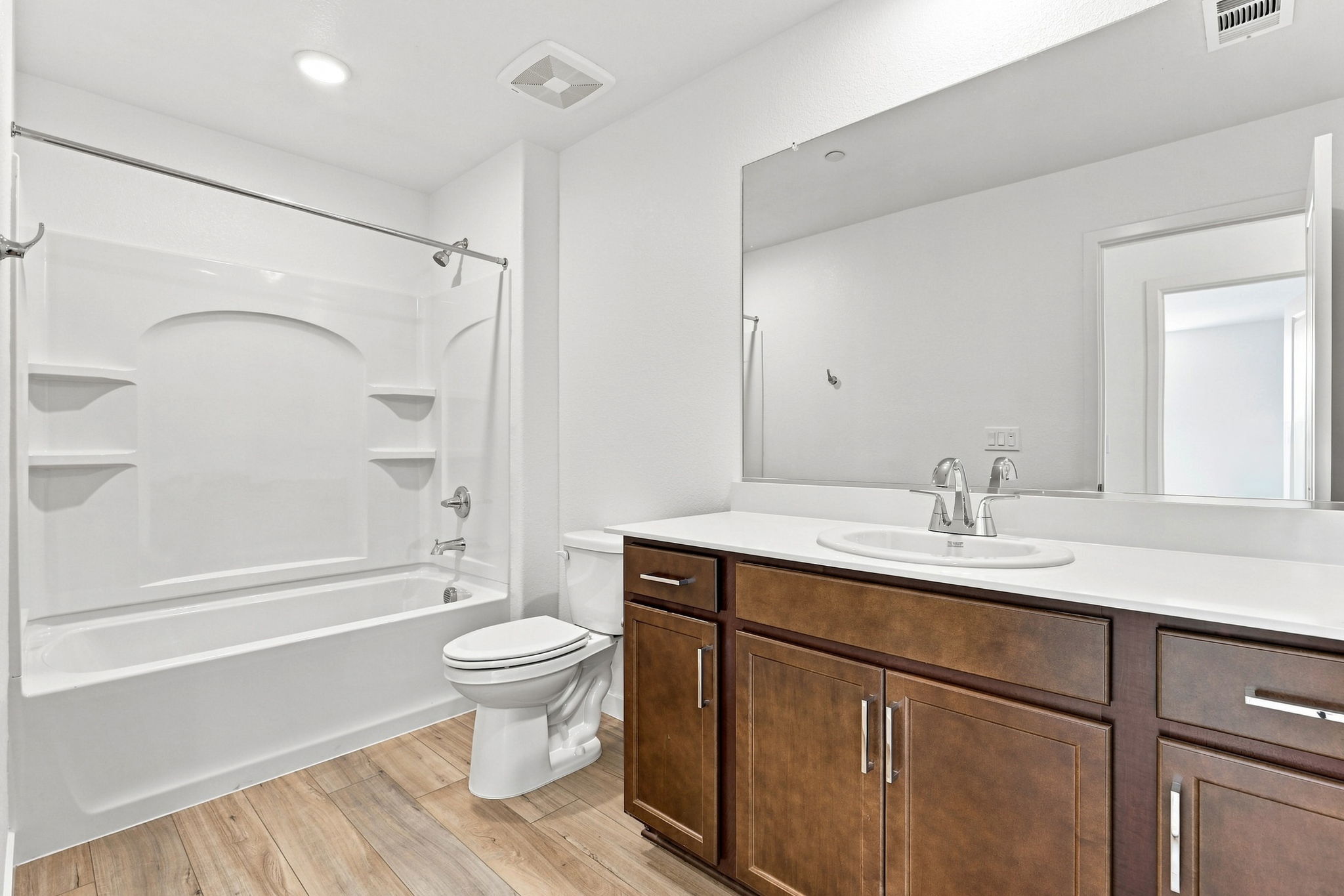 A bathroom with a tub sink and toilet.