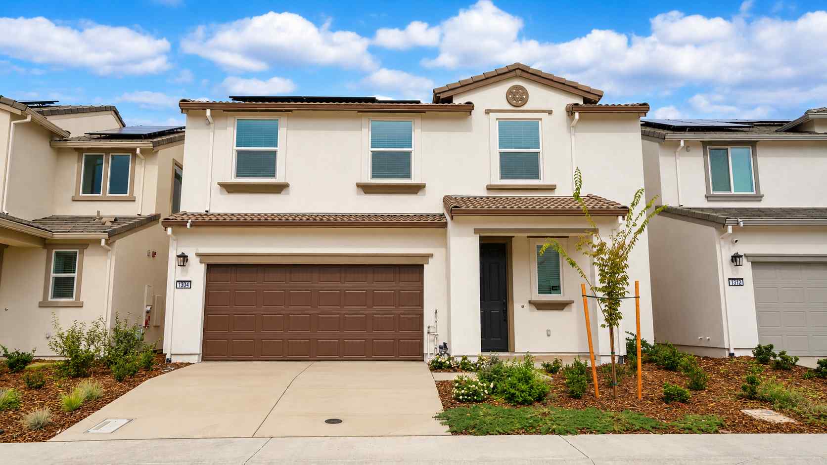 A white house with a garage.