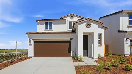 A white house with a garage.