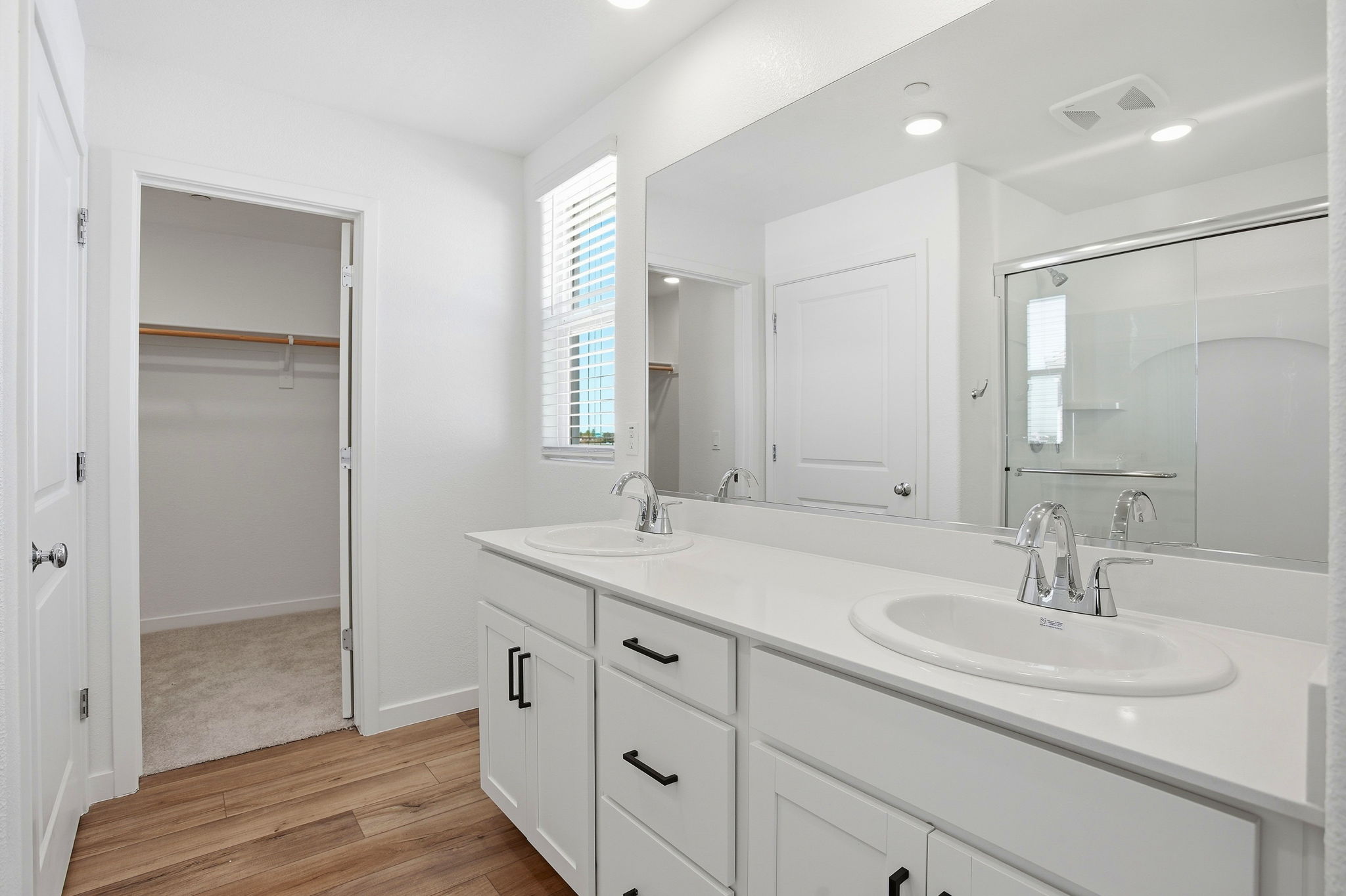 A bathroom with a large mirror.
