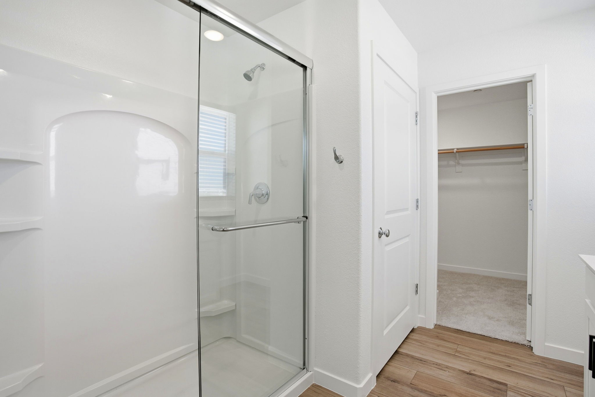 A bathroom with a shower unit.