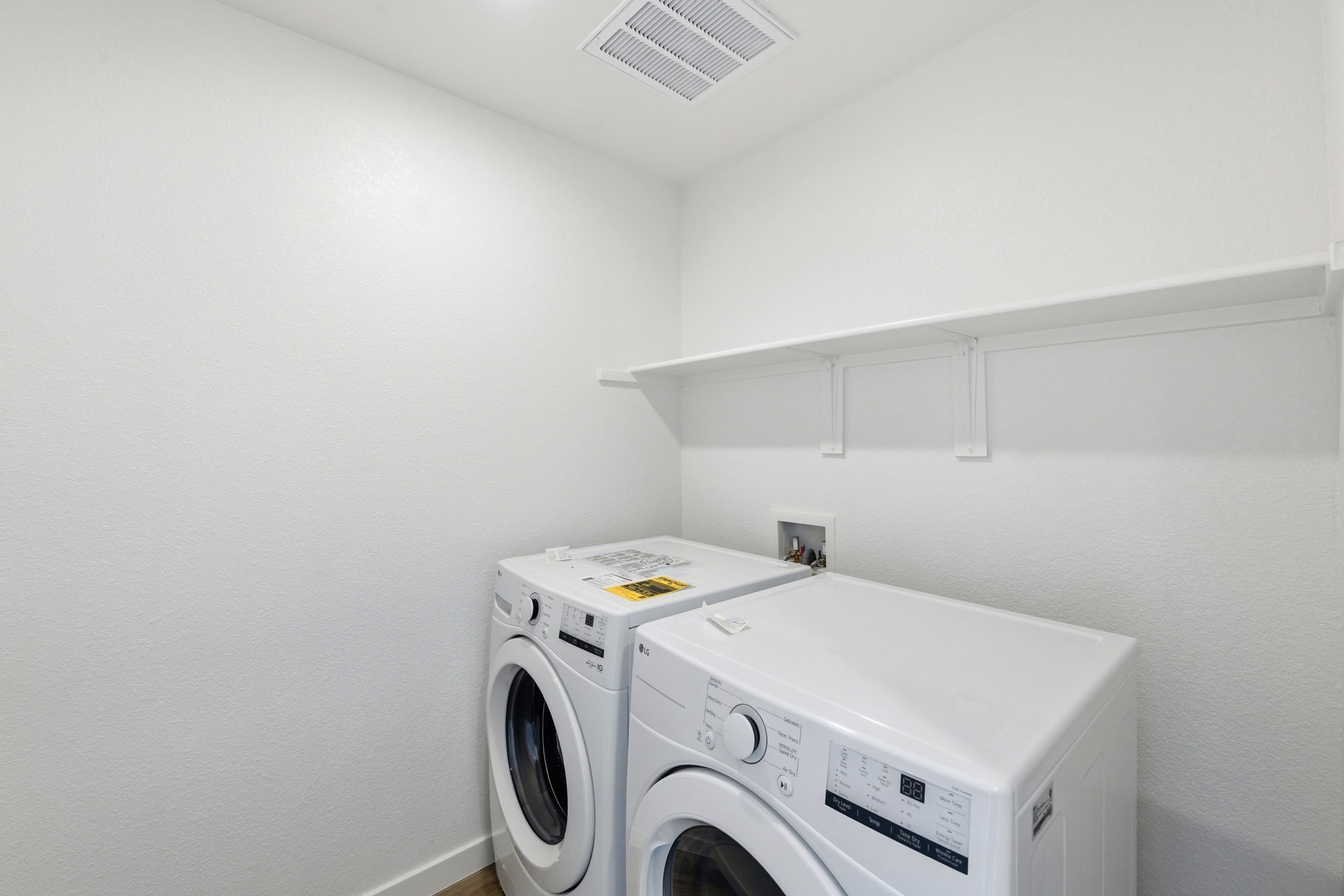 A washing machine in a room.