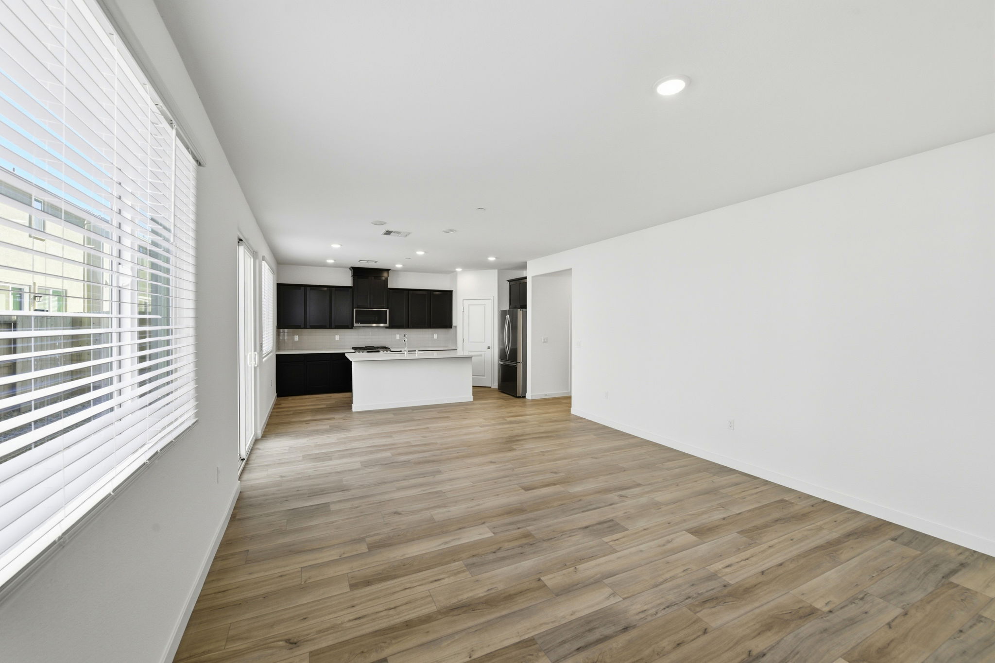 A room with white walls and wood floors.