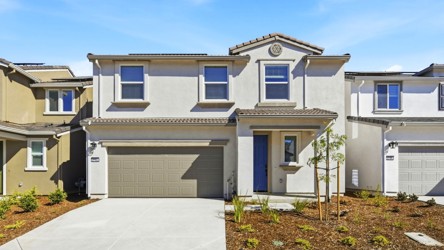 A white house with a garage.