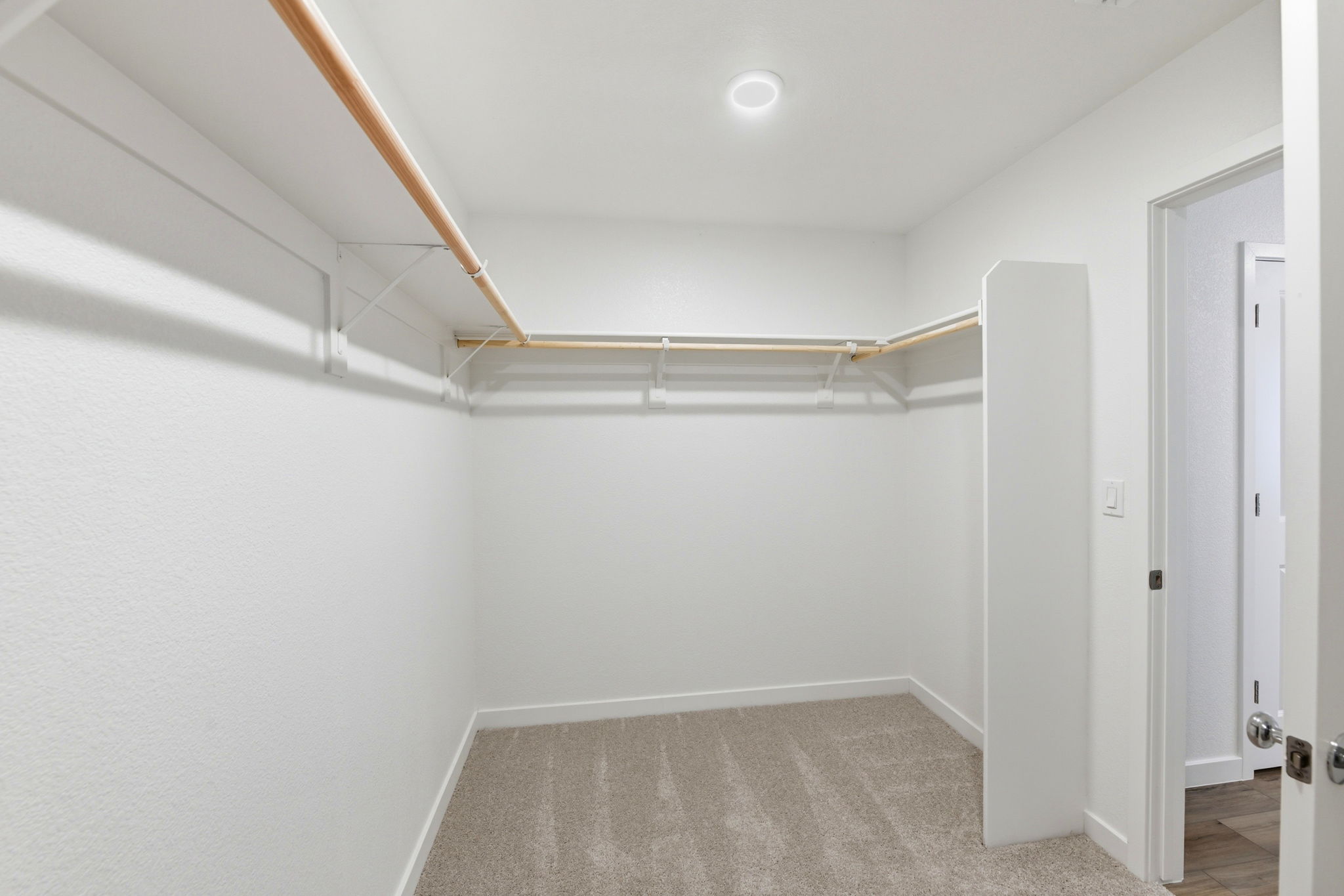 A hallway with white walls.