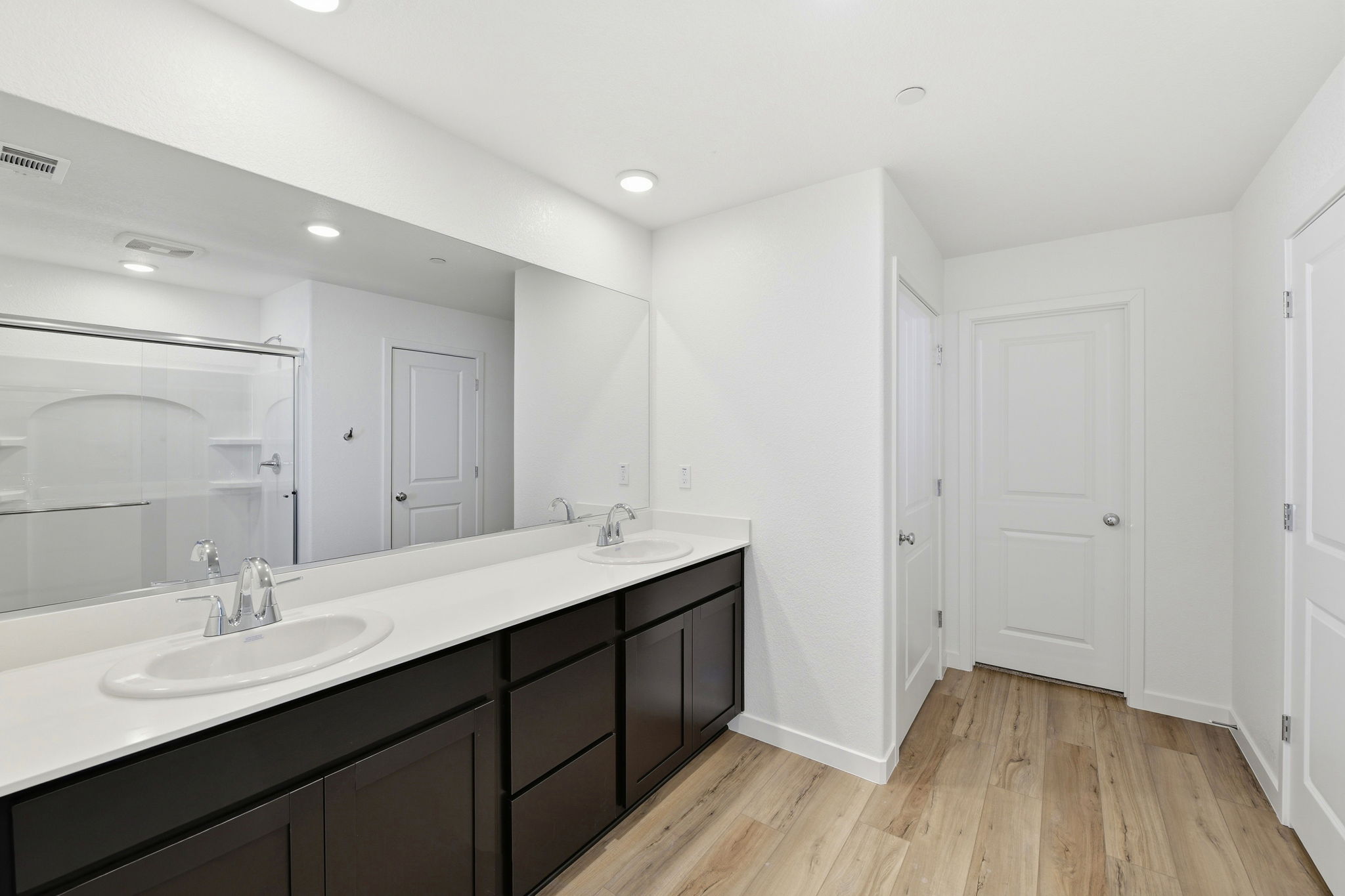 A bathroom with a large mirror.