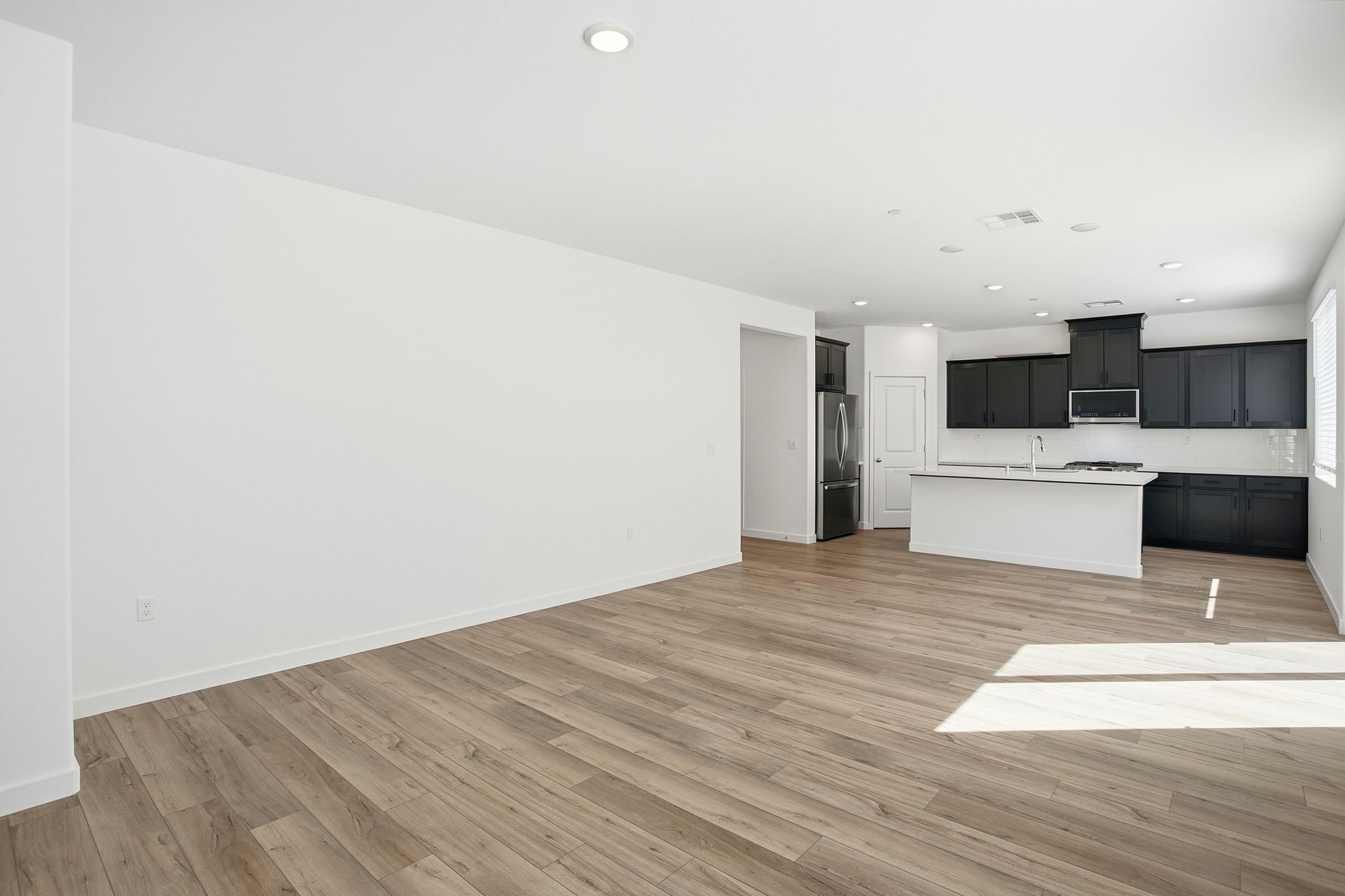 A room with a wood floor and white walls.