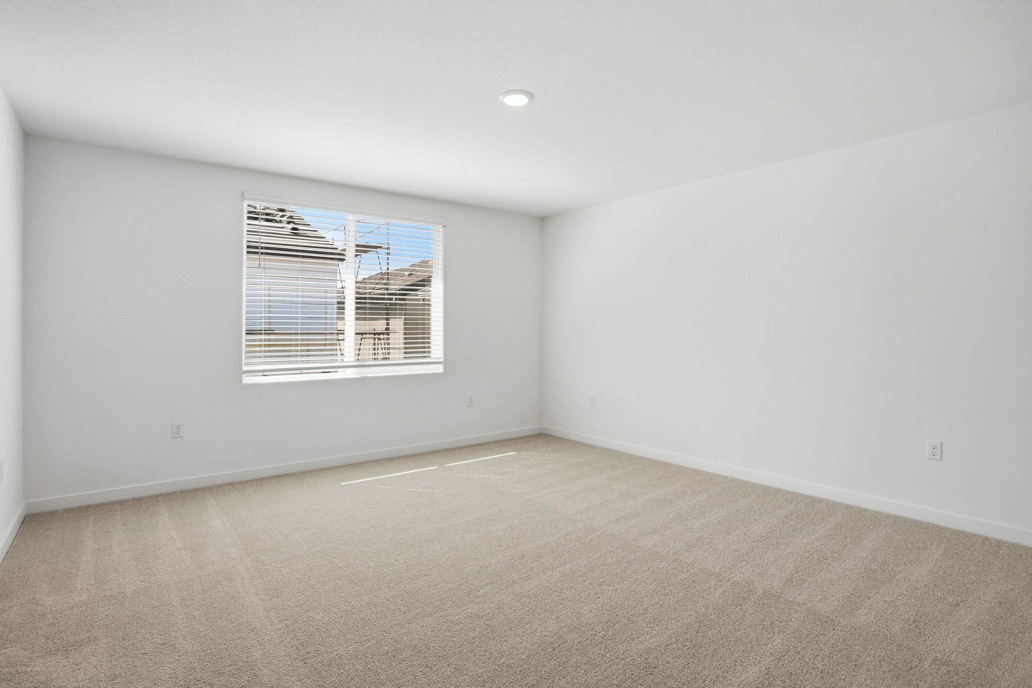 A room with a window and a carpet.