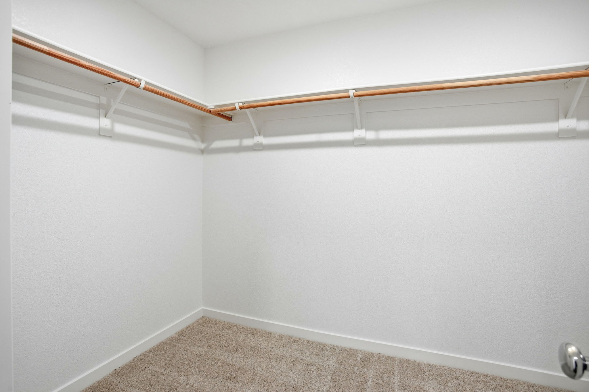 A white wall with a white ceiling.