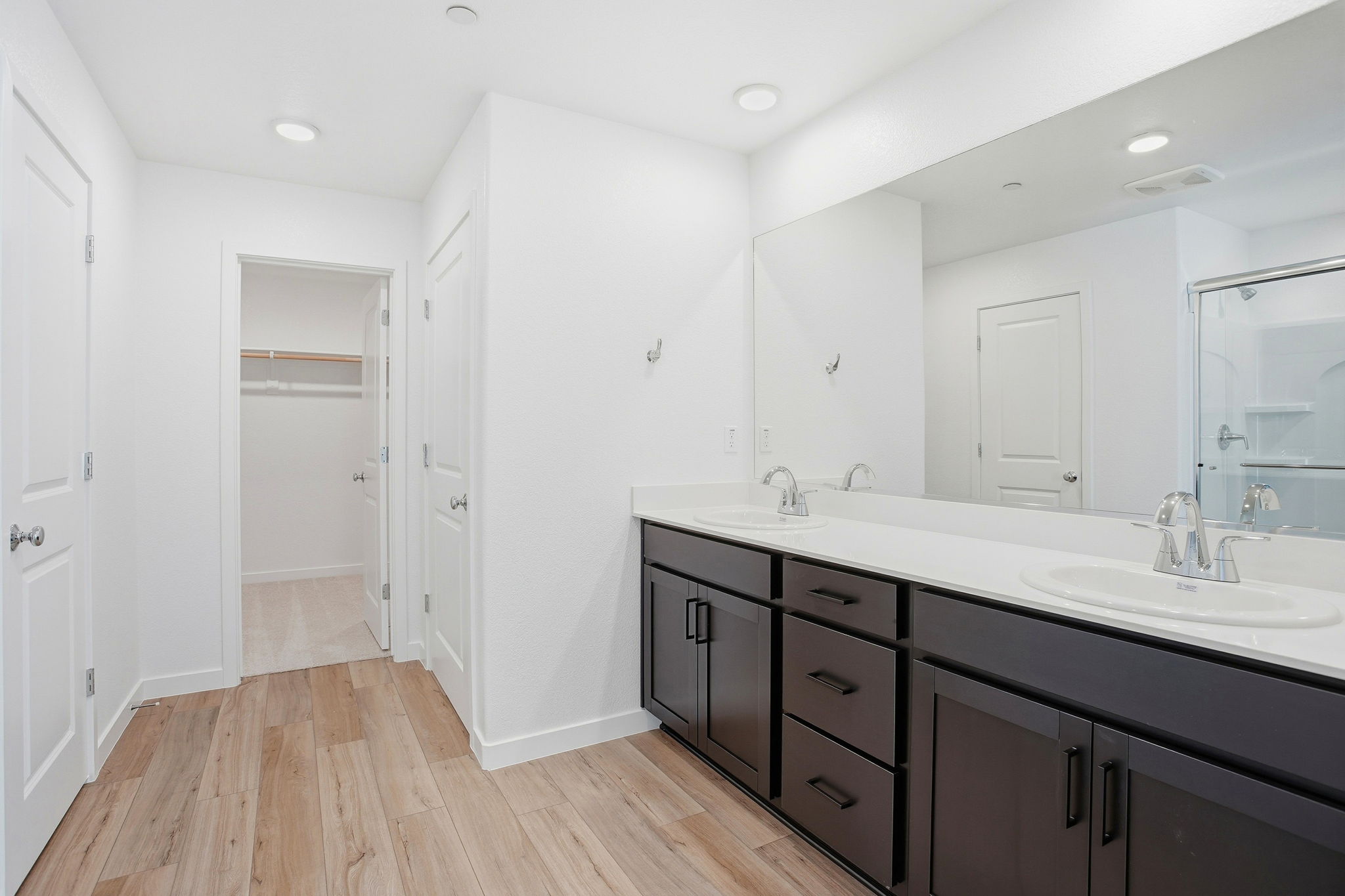 A bathroom with a large mirror.