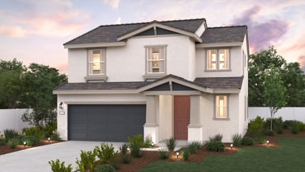 A white house with a garage.