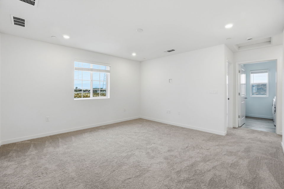 A room with white walls and a window.