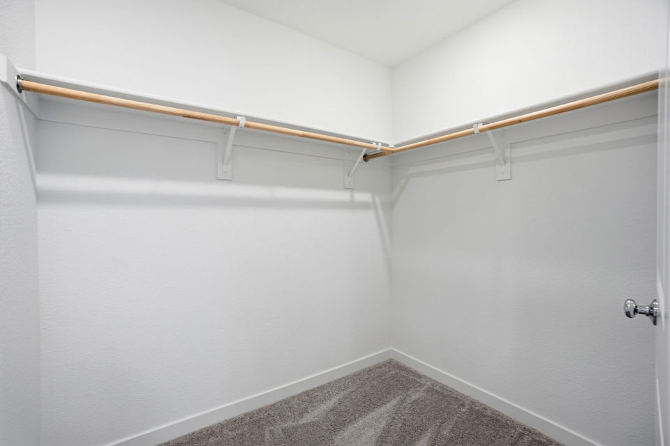 A white wall with a metal bar.