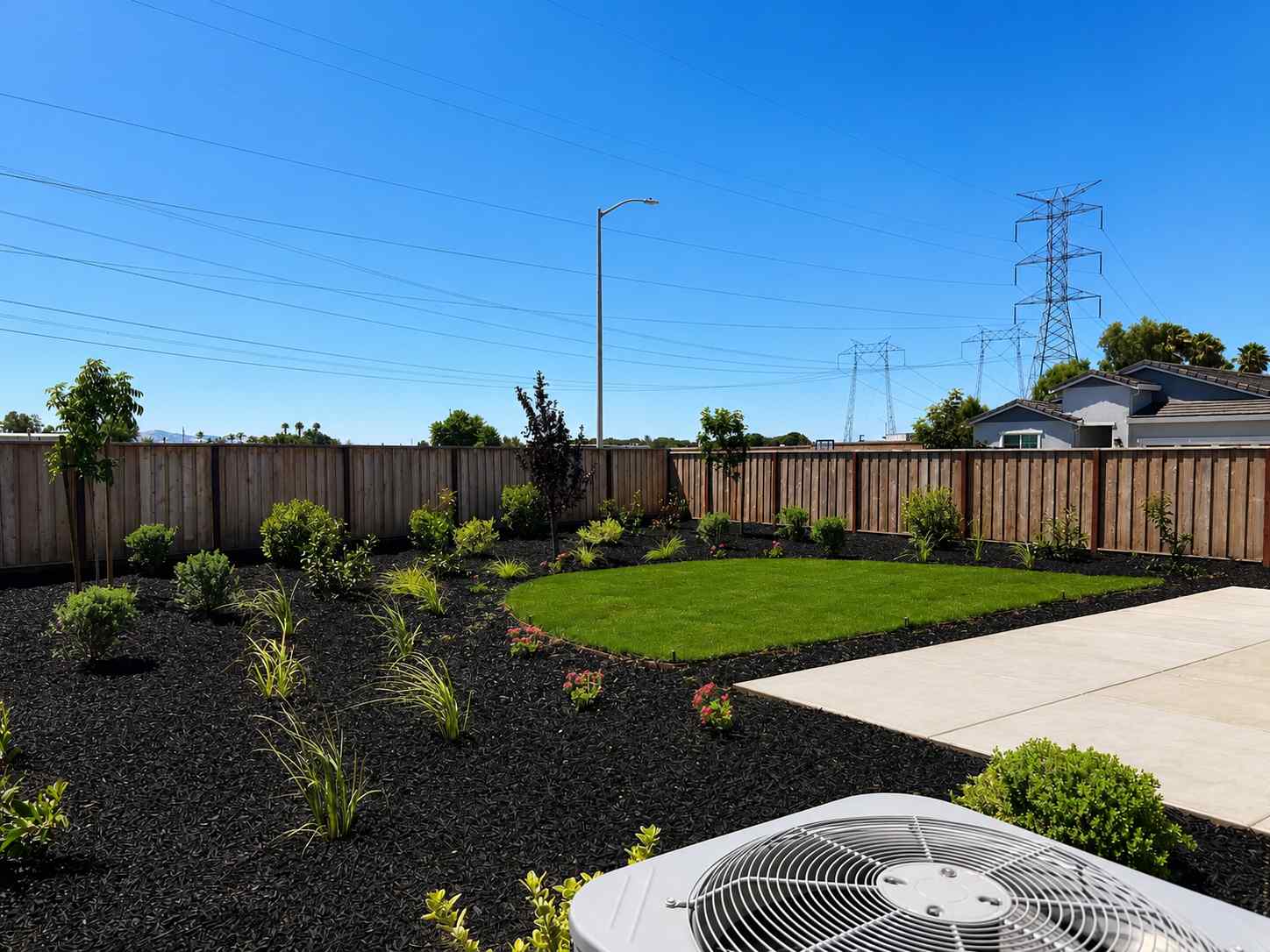 A backyard with a fence and a garden.