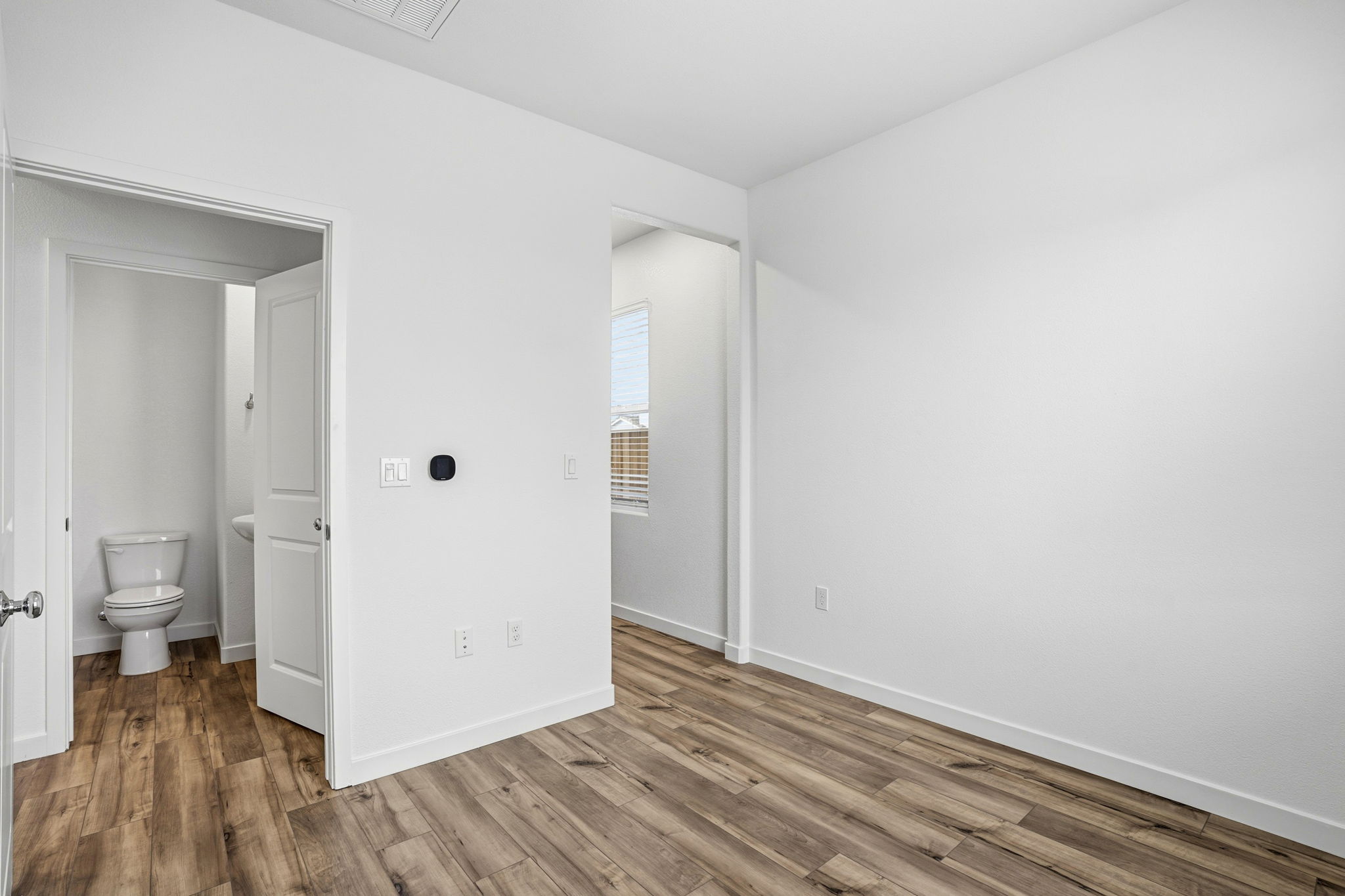 A bathroom with a wood floor.