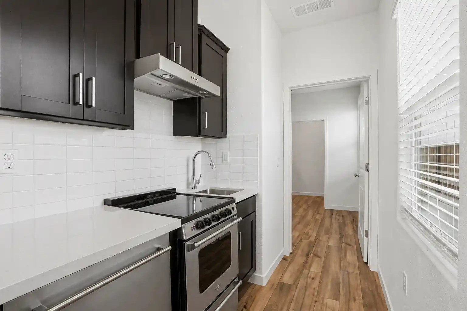 A kitchen with white walls.