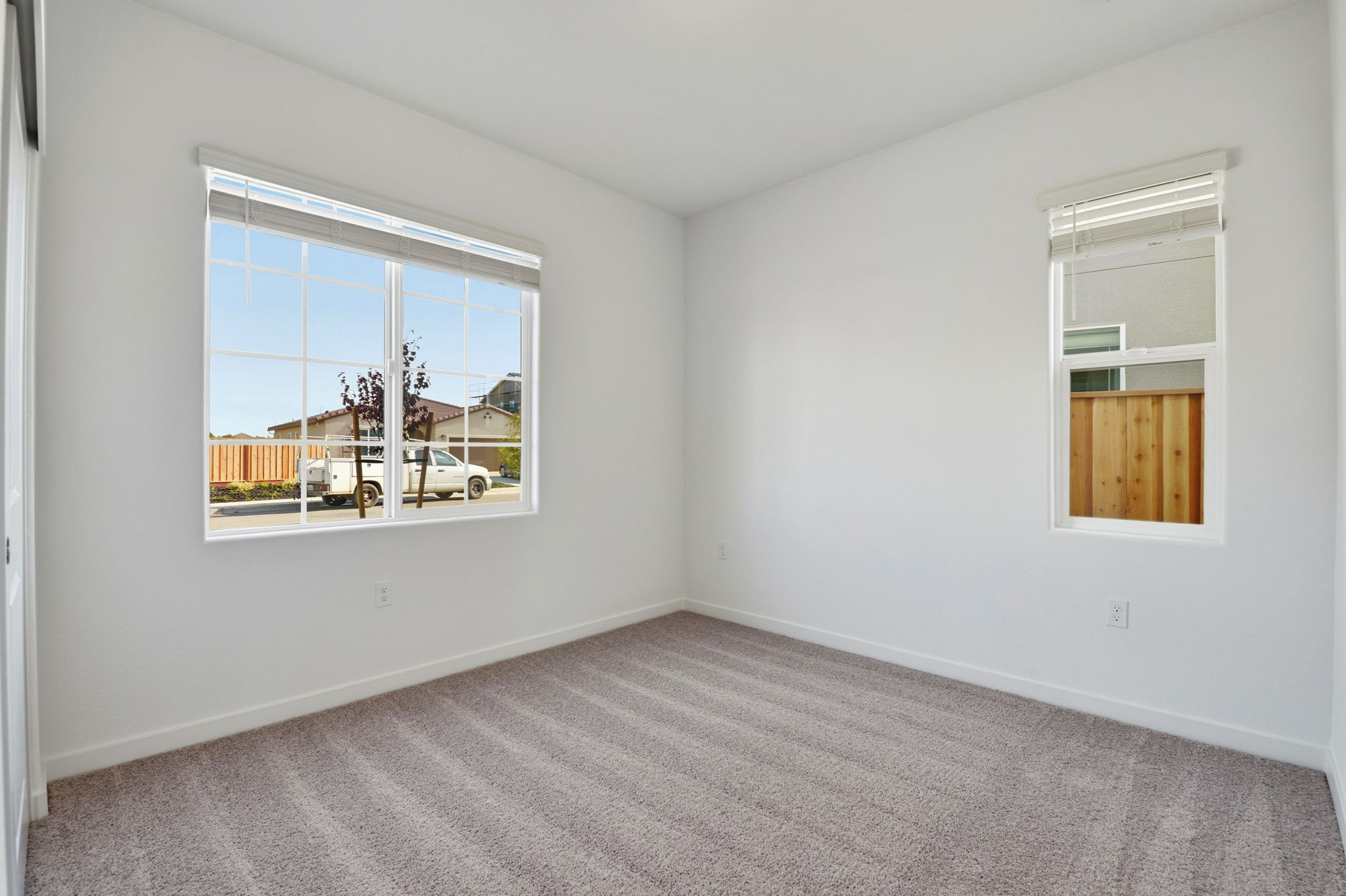 A room with a window and a car outside.