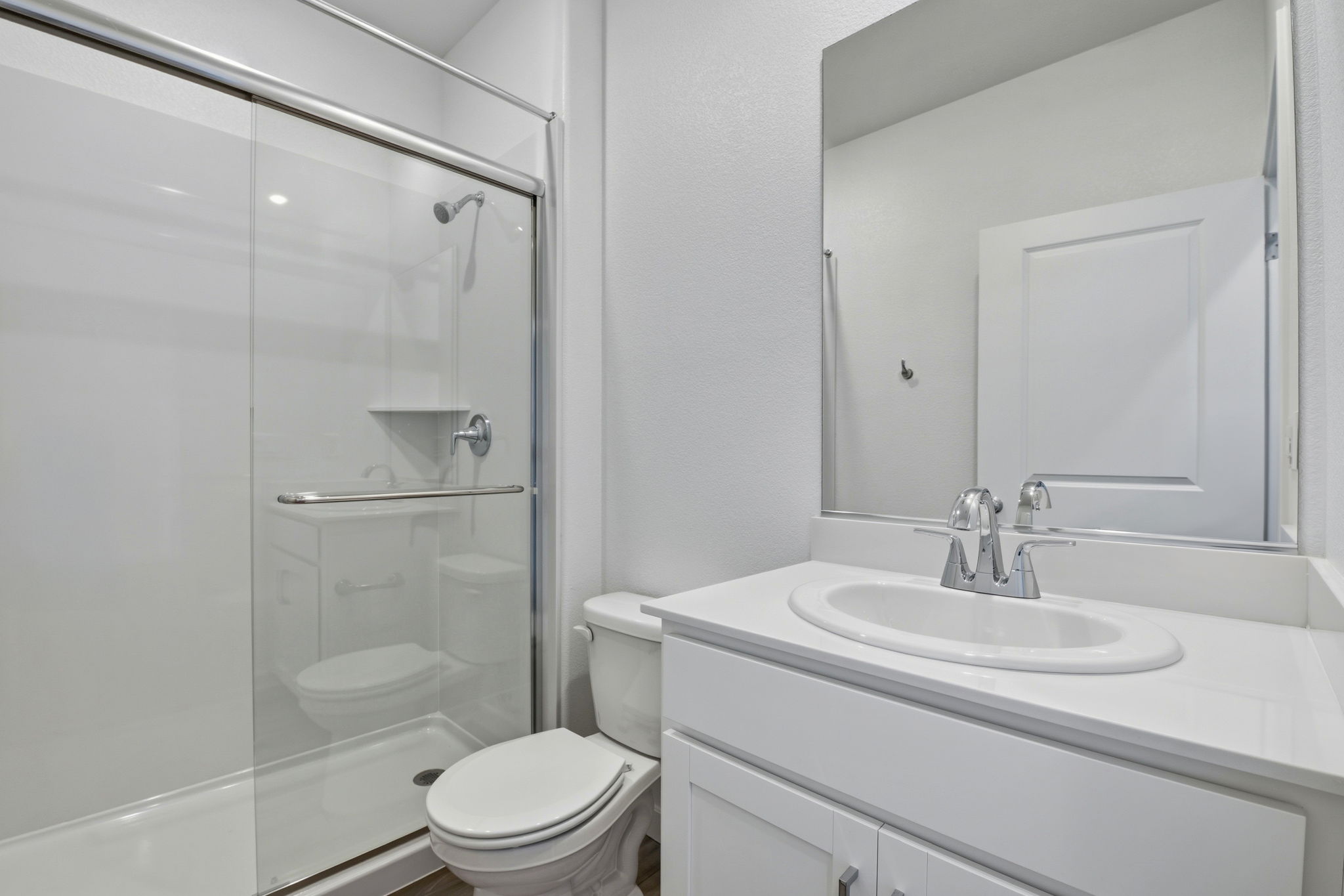 A bathroom with a glass shower.