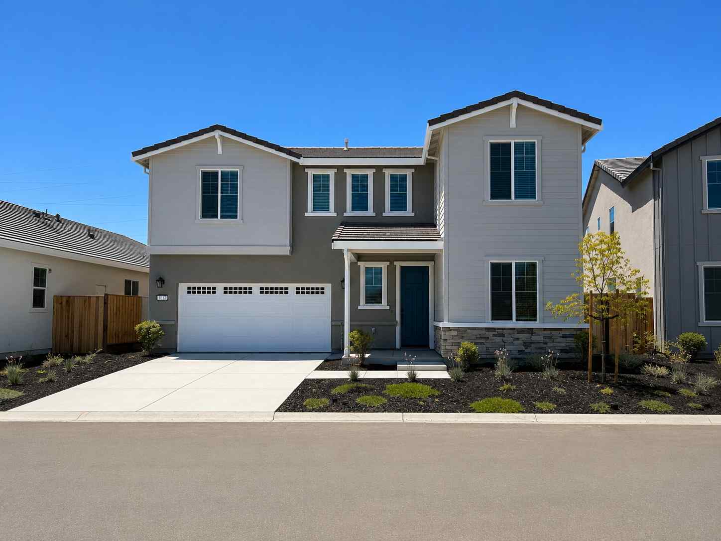 A white house with a driveway.