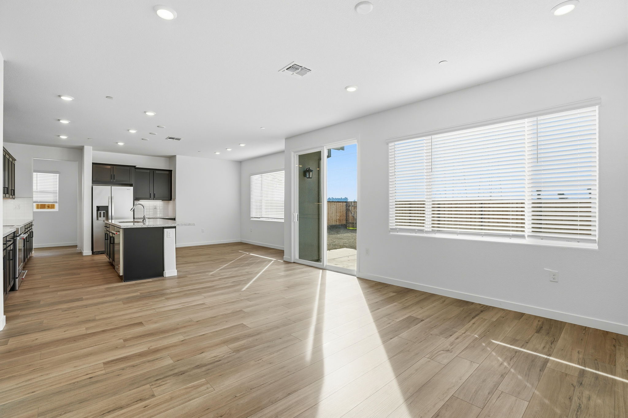 A large empty room with a wood floor and a wood floor.
