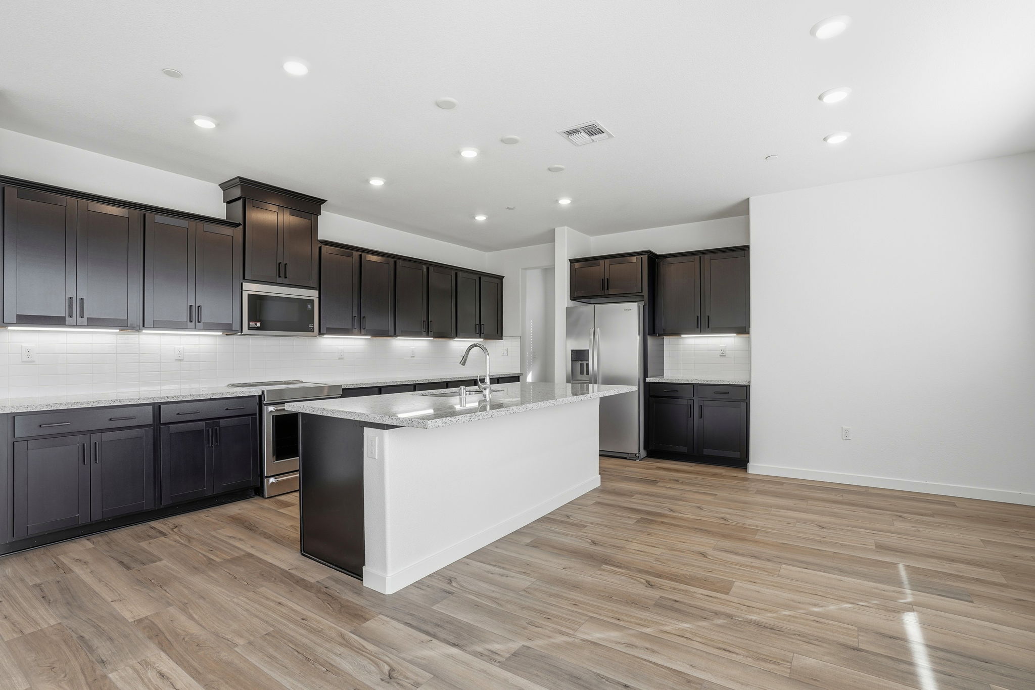 A kitchen with black cabinets.